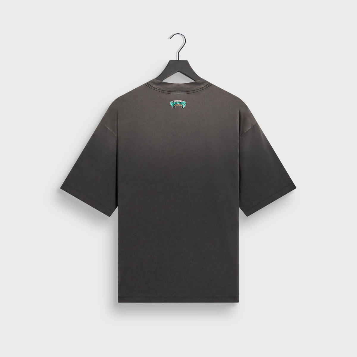 Kith for the Vancouver Grizzlies Vintage Jones II tee in faded black on hanger, back view with small teal Grizzlies logo below collar