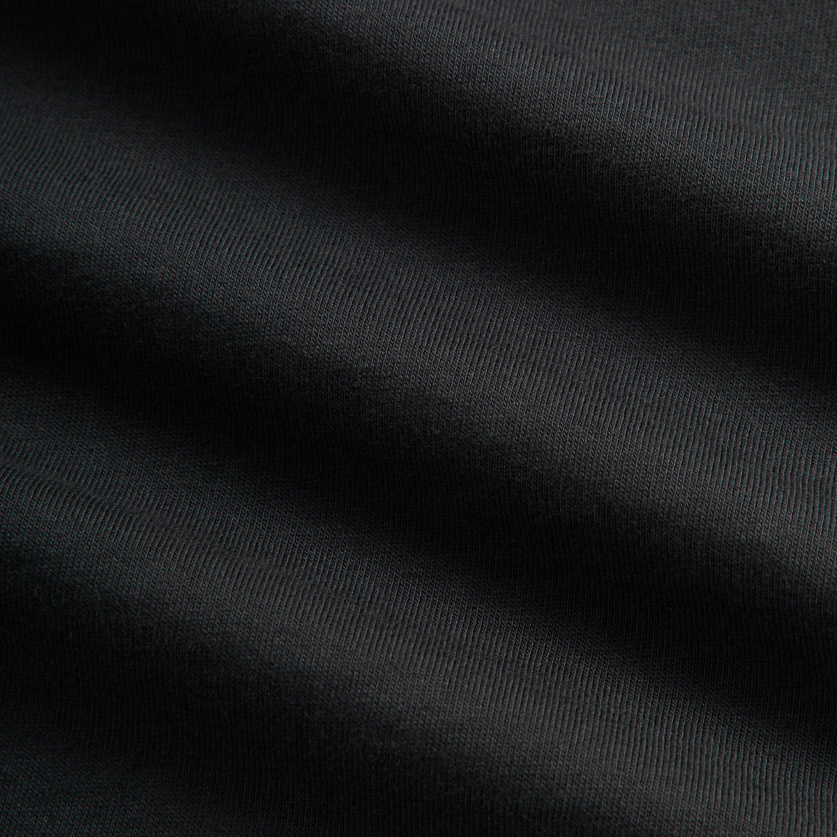 Close-up of black cotton jersey fabric texture on the Kith Vancouver Geometric long sleeve tee
