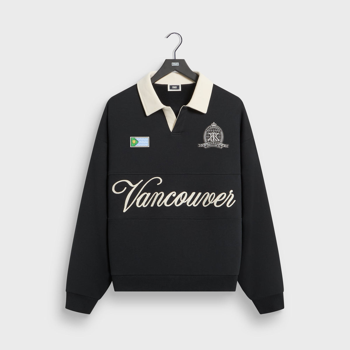 Kith Vancouver Nelson rugby in black with cream collar, front view with script Vancouver embroidery, flag and crest patches on hanger