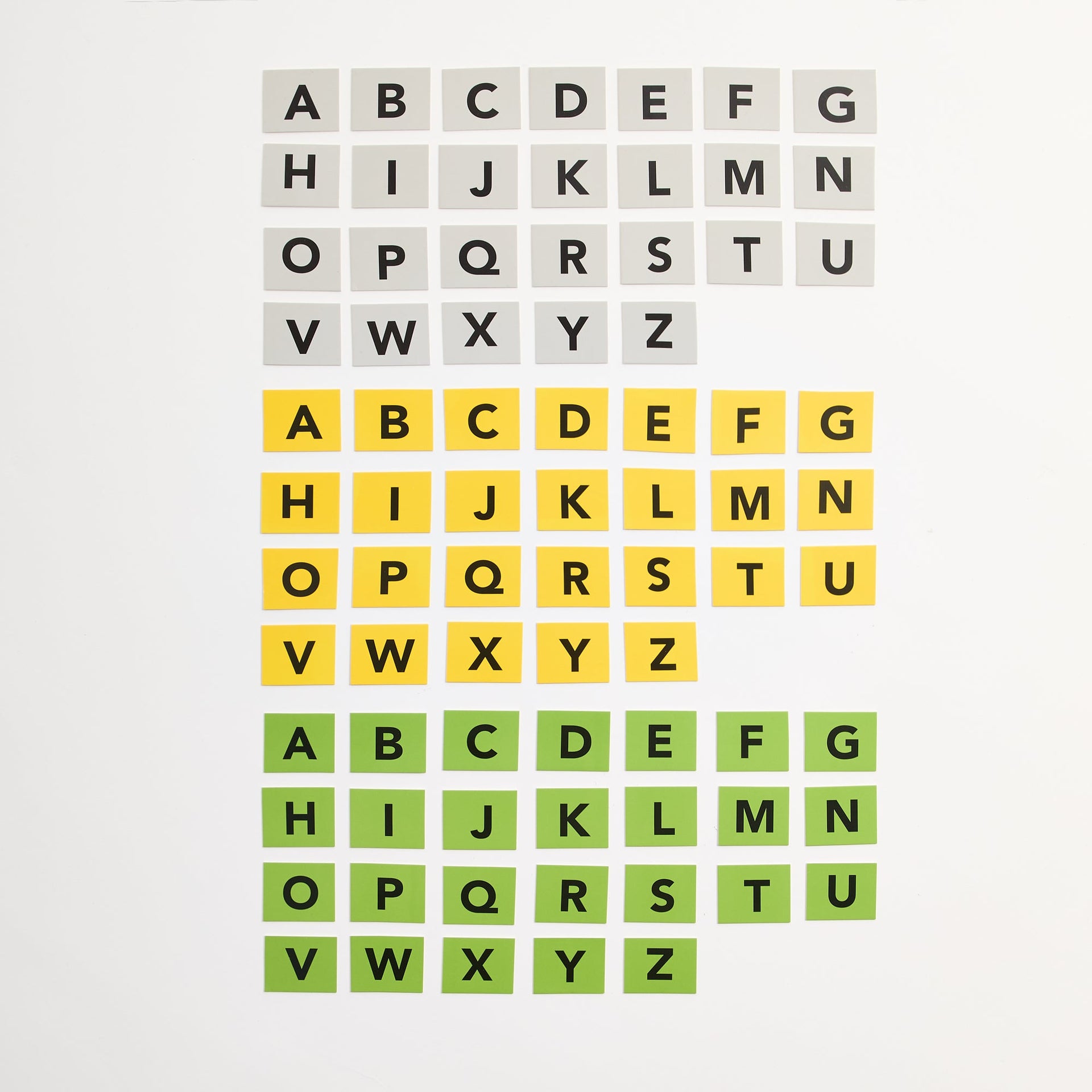 Five Letter Fix game letter tiles laid out in full gray, yellow and green alphabets on white background