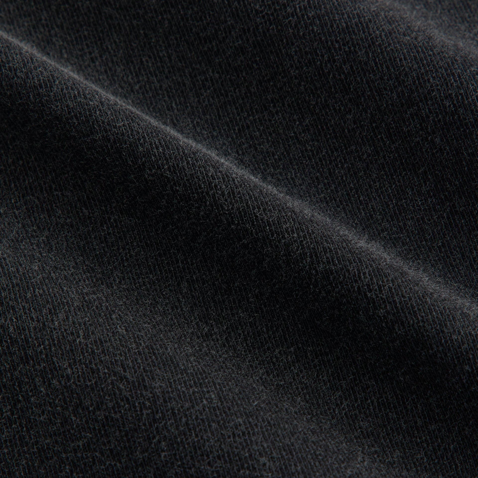 Fabric detail of Kith Treats Matcha Swirl Vintage Tee showing washed black cotton jersey texture