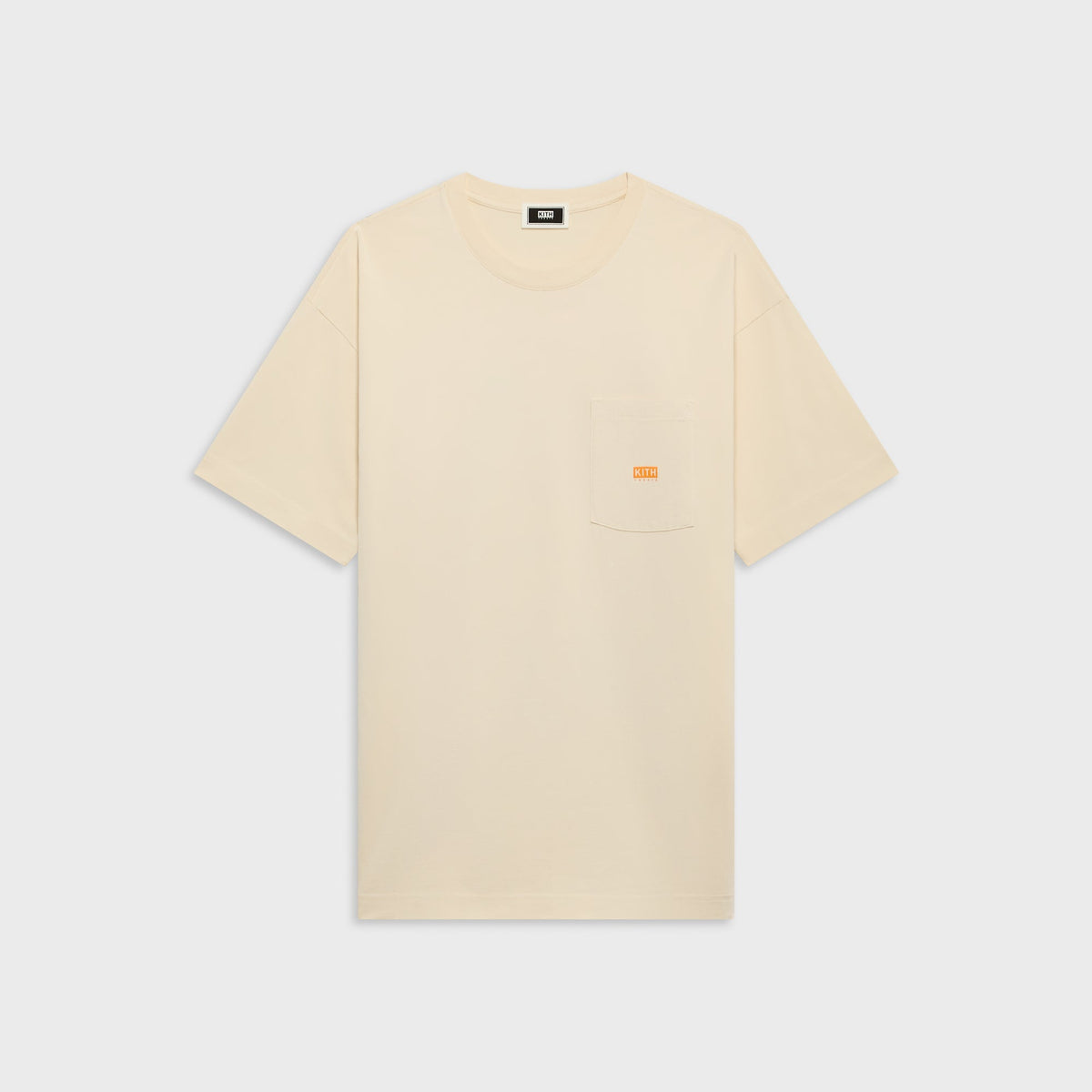 Kith Treats Pumpkin Harvest Pocket Tee in Sandrift cream, front view with small orange Kith Treats pocket logo
