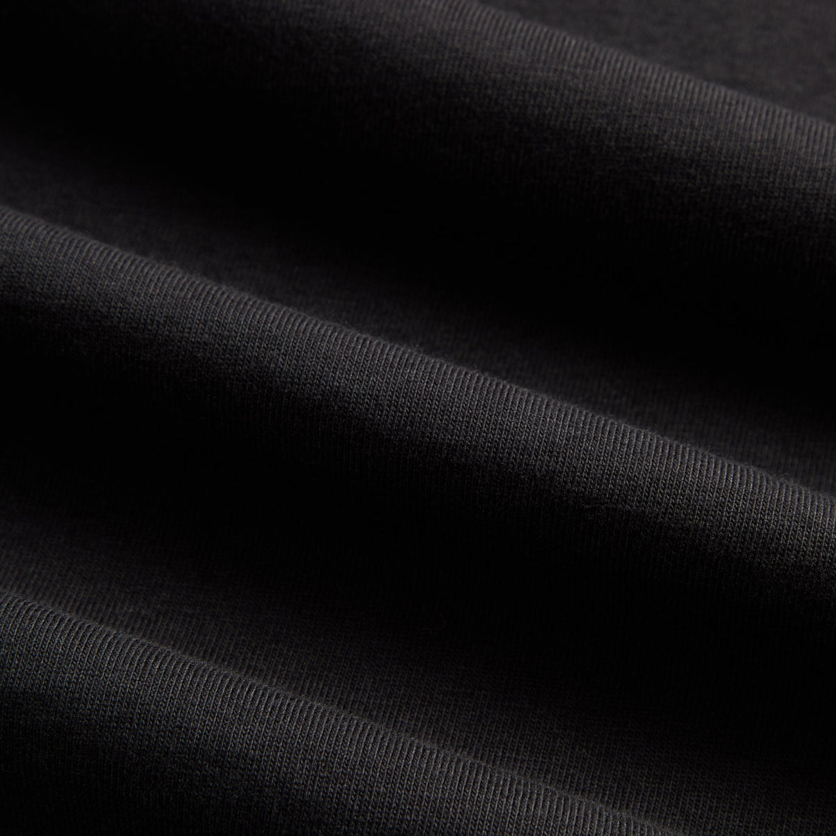 Macro detail of black cotton jersey fabric texture on Kith Treats for Katz's Delicatessen T-shirt
