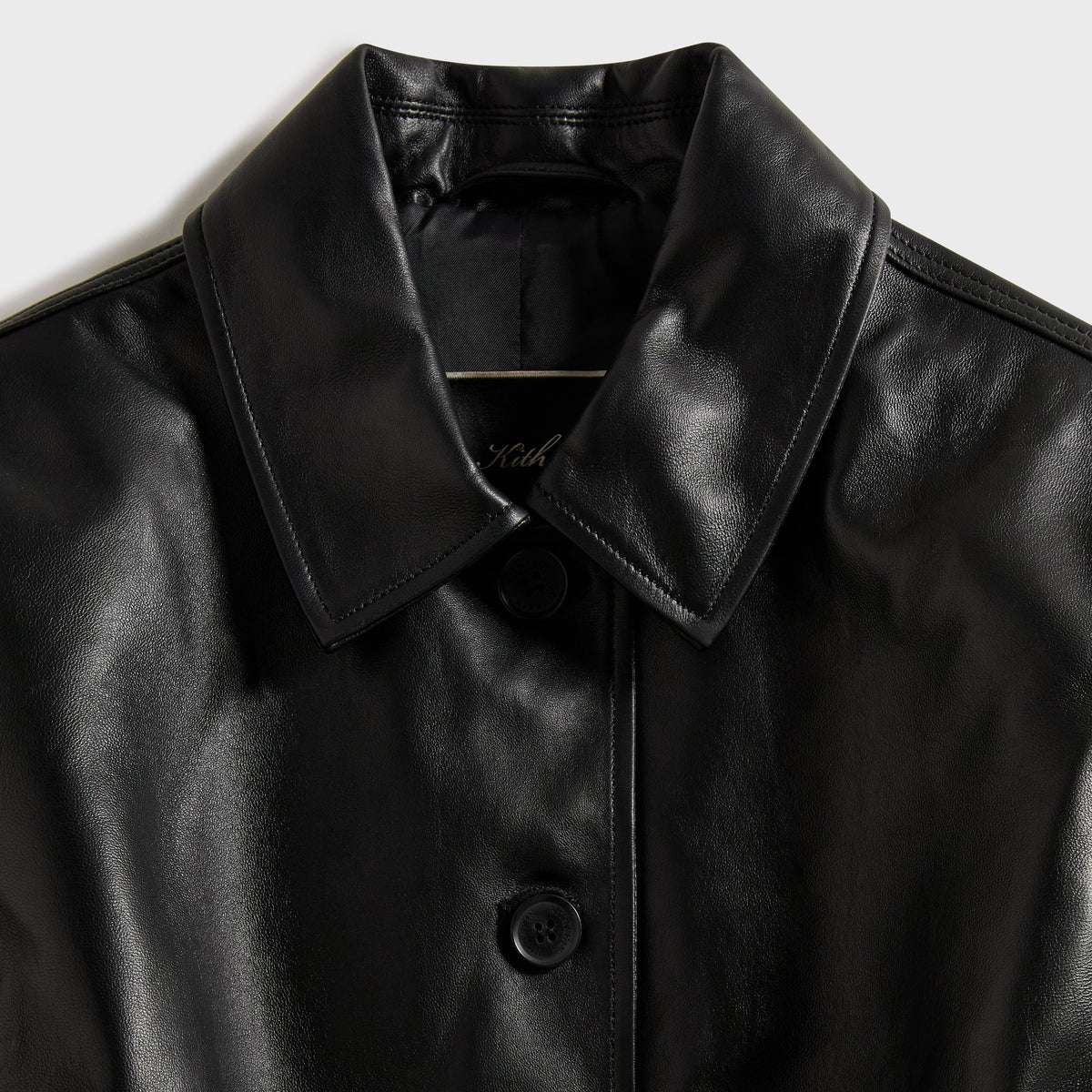 Close-up of the collar and top button with Kith script on the Vivien leather corset jacket