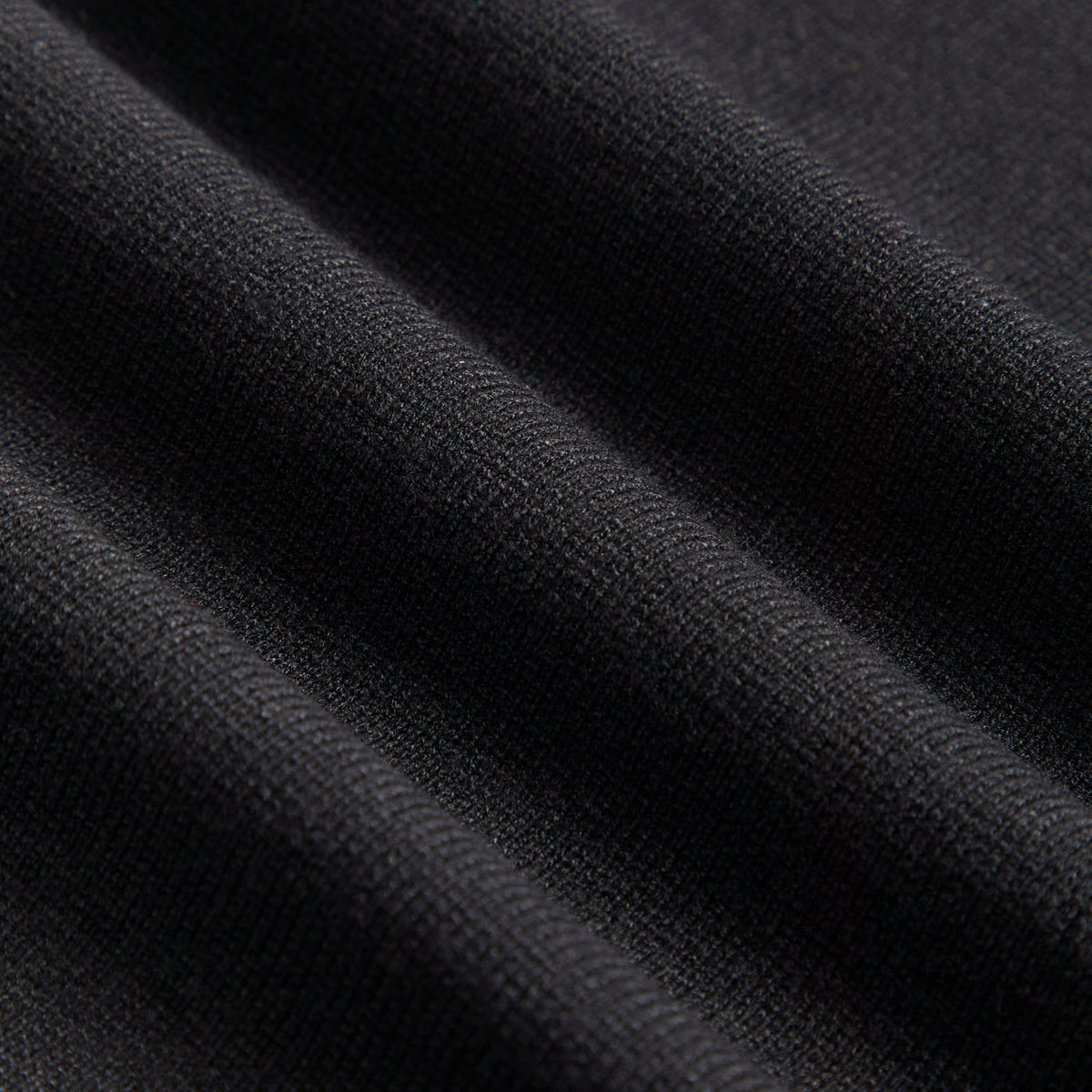 Close-up of the black knit fabric texture on the Kith Women Aria belt tank