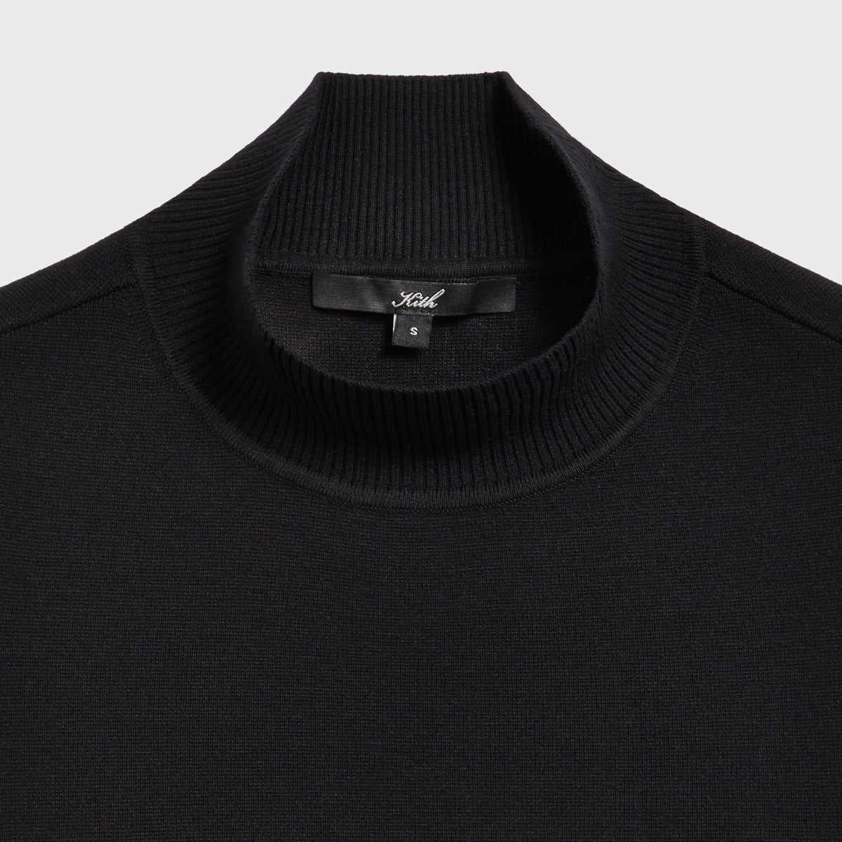 Close-up of the mock neck collar and Kith label on the Aria belt tank in black