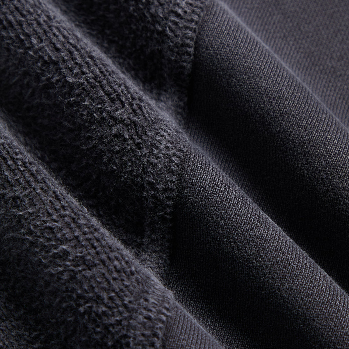 Close-up of the textured knit sleeve panel against smooth fleece on the Kith Elvina paneled hoodie
