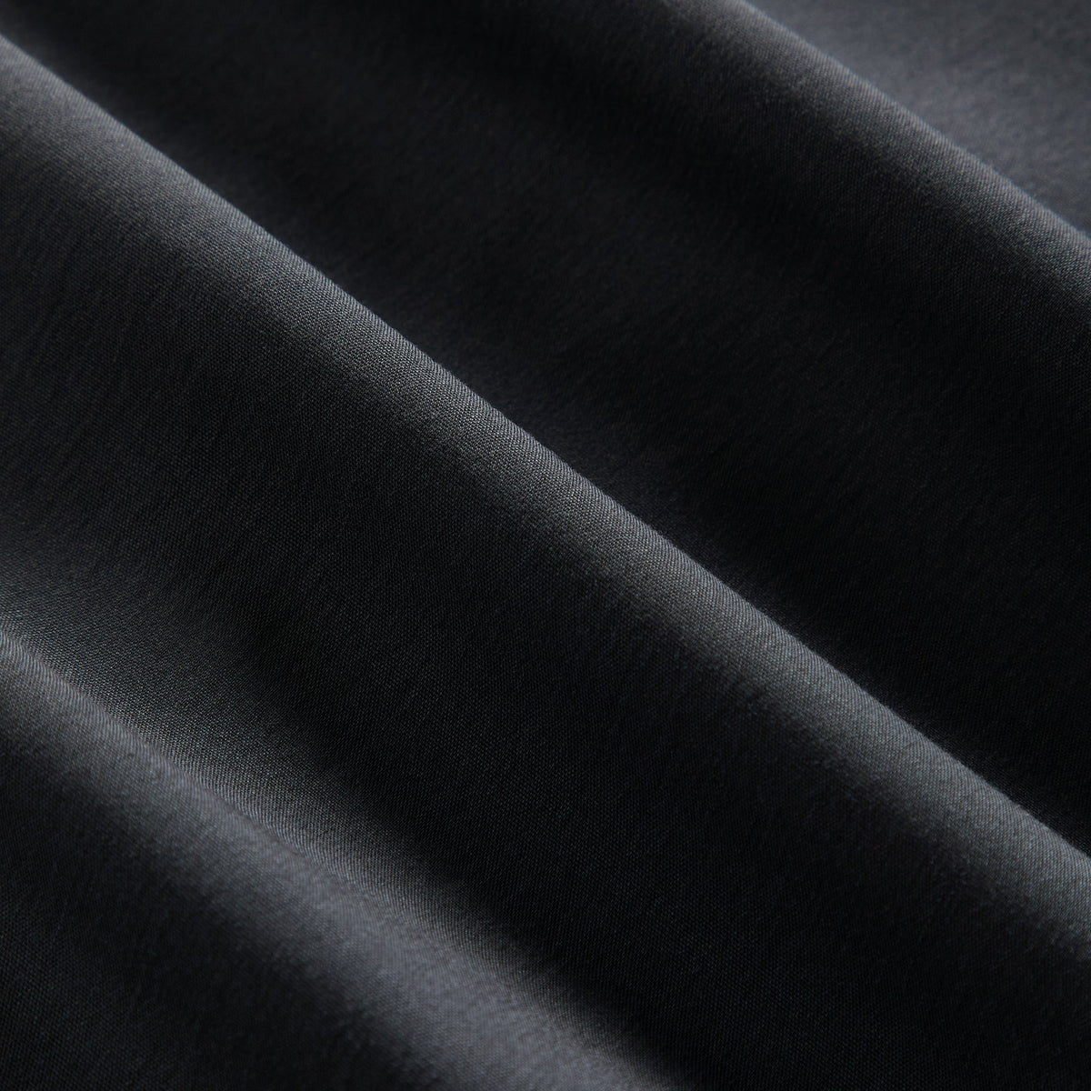 Close-up of the black poplin fabric texture on the Kith Women Camilla plunge shirt