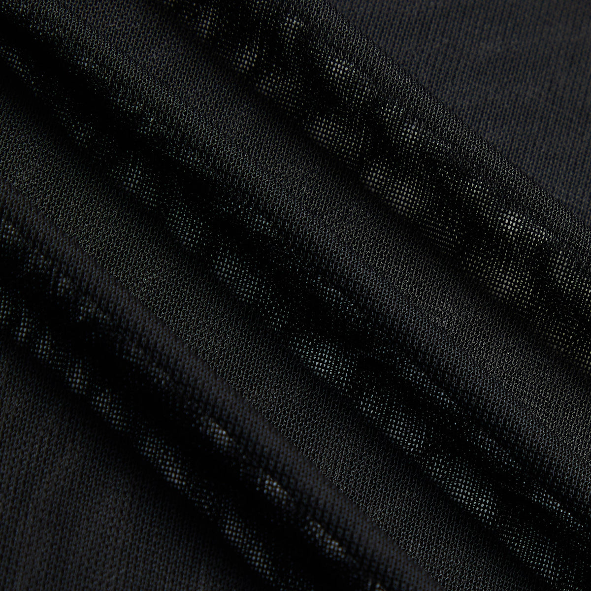 Close-up of the sheer black mesh fabric weave on the Kith Women Nori Line long sleeve tee