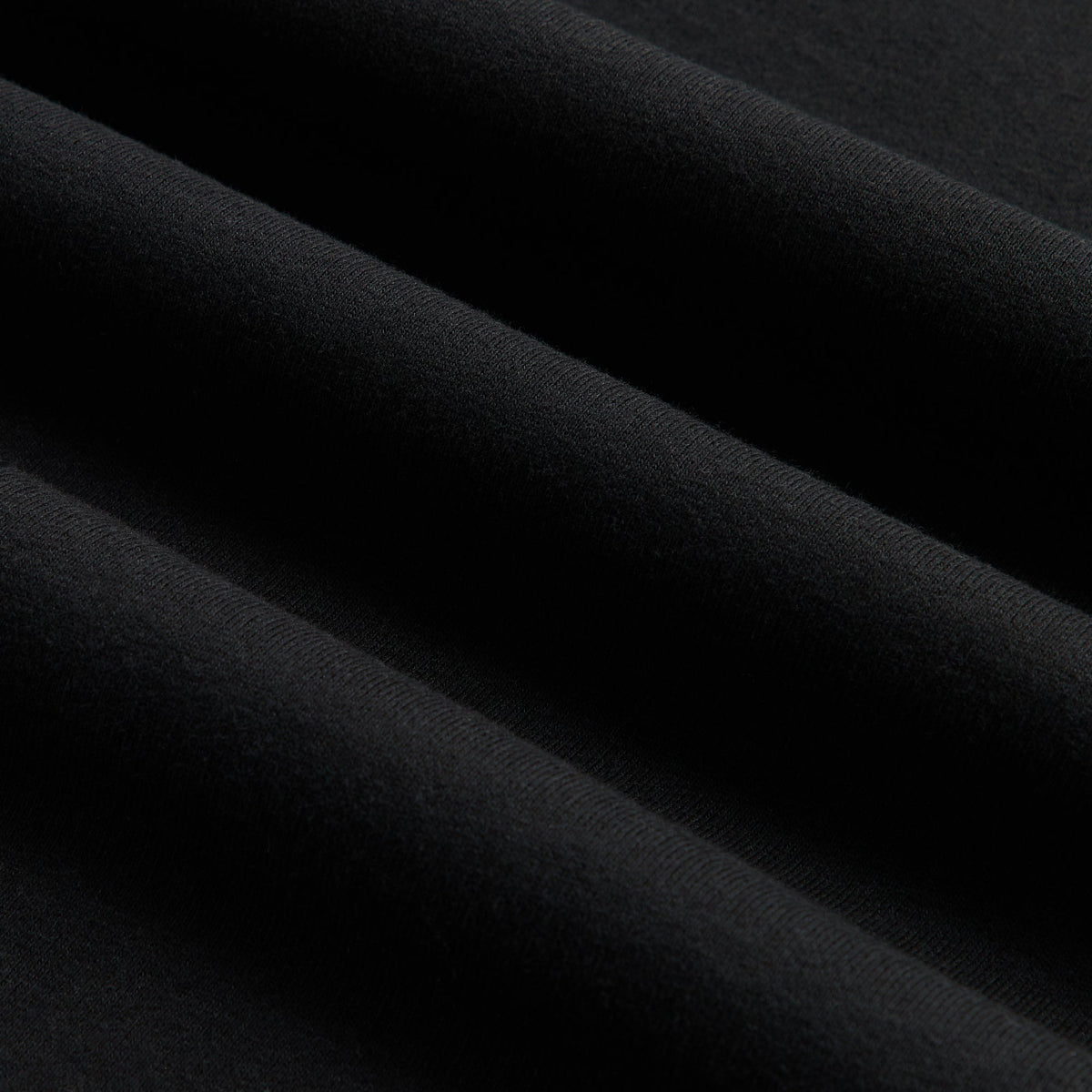 Close-up of the faded black cotton fabric texture on the Kith Women Mulberry vintage crystal serif tee