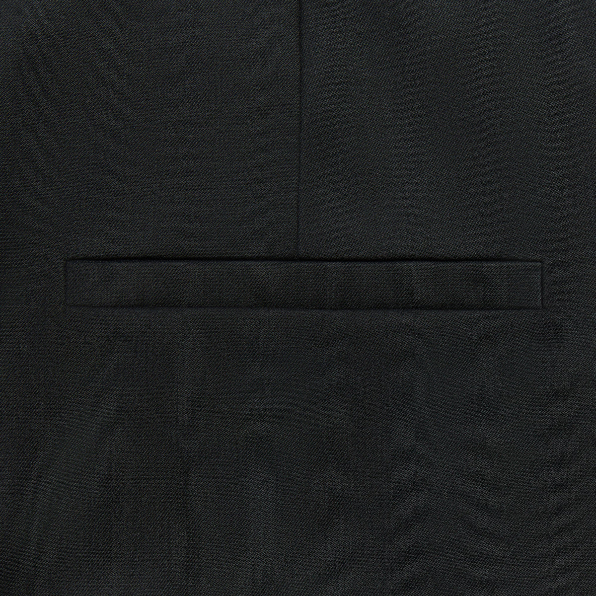 Close-up of the back besom pocket on the Kith Women Tallis waist strap suiting trouser in black