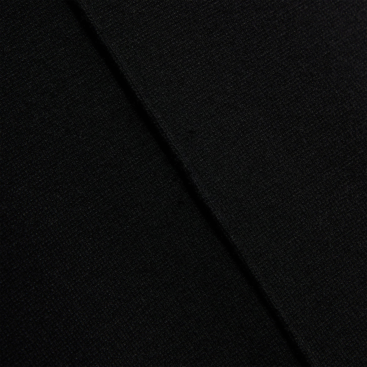 Close-up of the center back seam on the Kith Piper II sleeveless mini dress in black knit