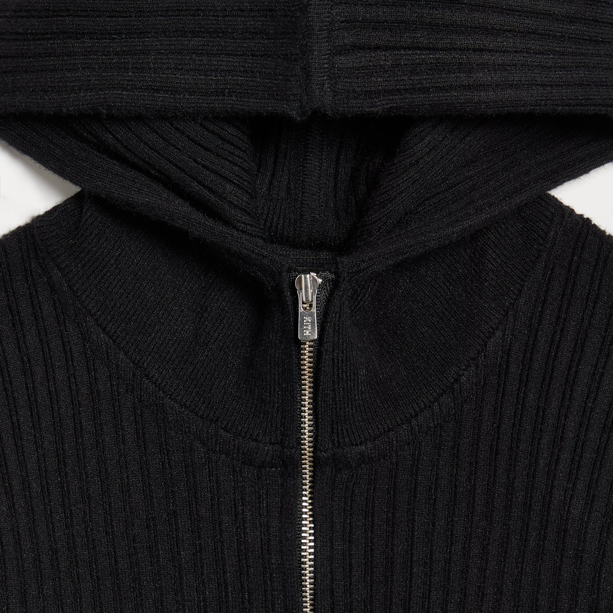 Close-up of the hood zipper pull engraved with Kith on the Amayna backless mini dress