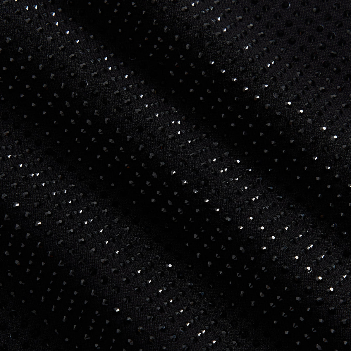Close-up of the allover crystal stud texture on the Kith Women Ina II track jacket in black