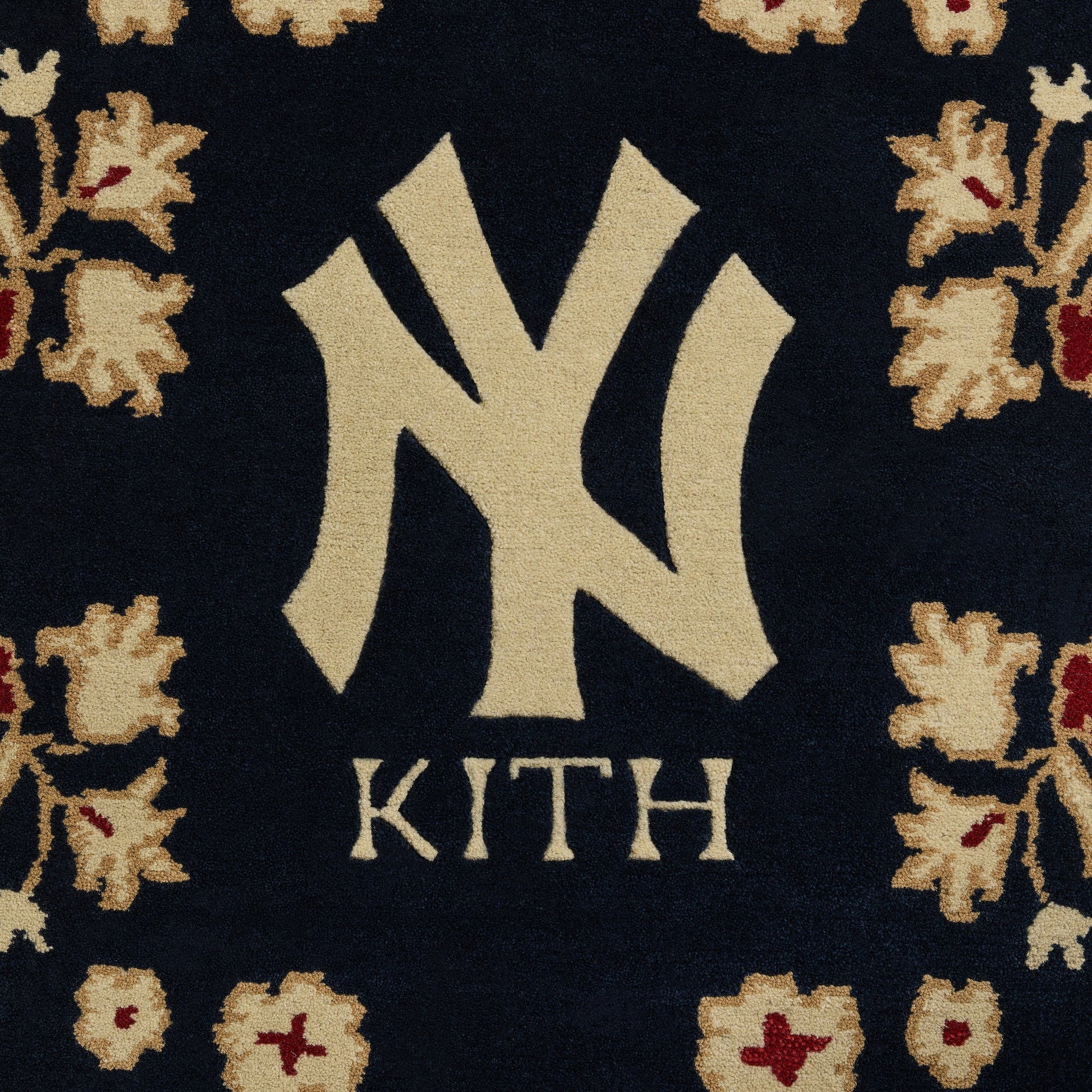 Close-up of center medallion on Multi colorway Kith x Yankees 8x10 rug showing tufted NY logo and KITH wordmark
