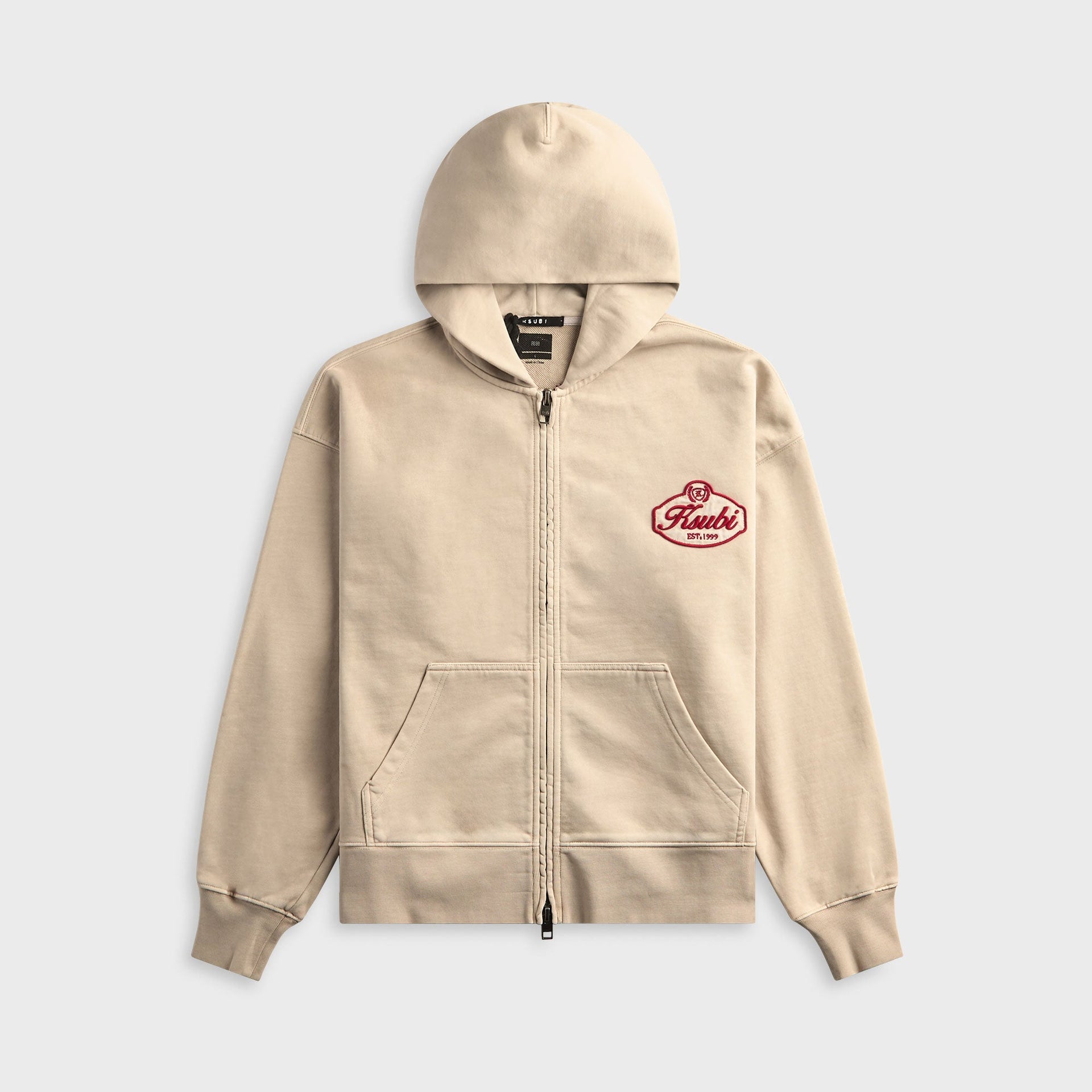 Ksubi Klasse Halen full-zip hoodie in stone beige with a burgundy Ksubi EST 1999 crest on the chest, front view