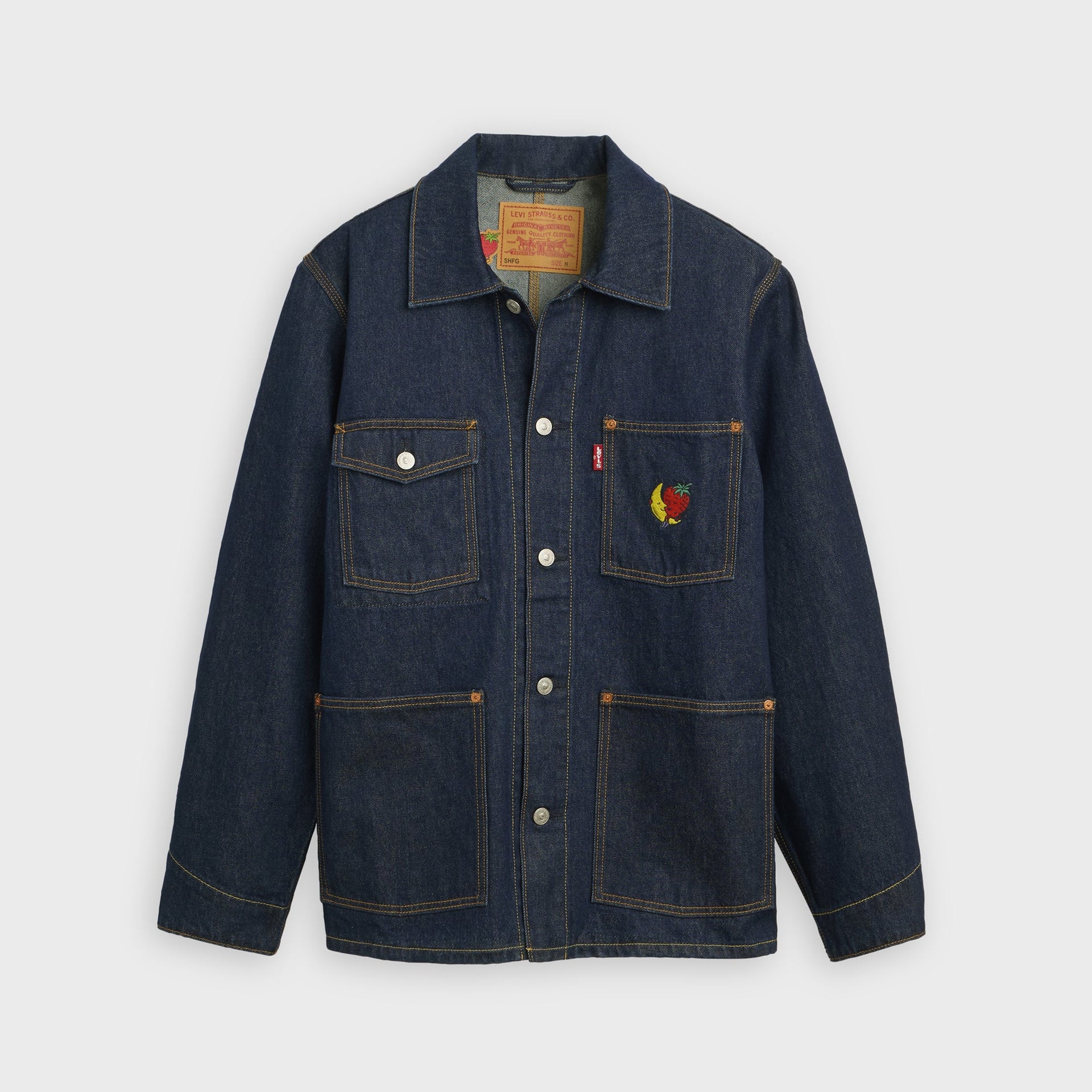 Levi's x Sky High Farm Goods dark rinse denim chore coat, front view with three patch pockets and embroidered banana-and-strawberry mascot
