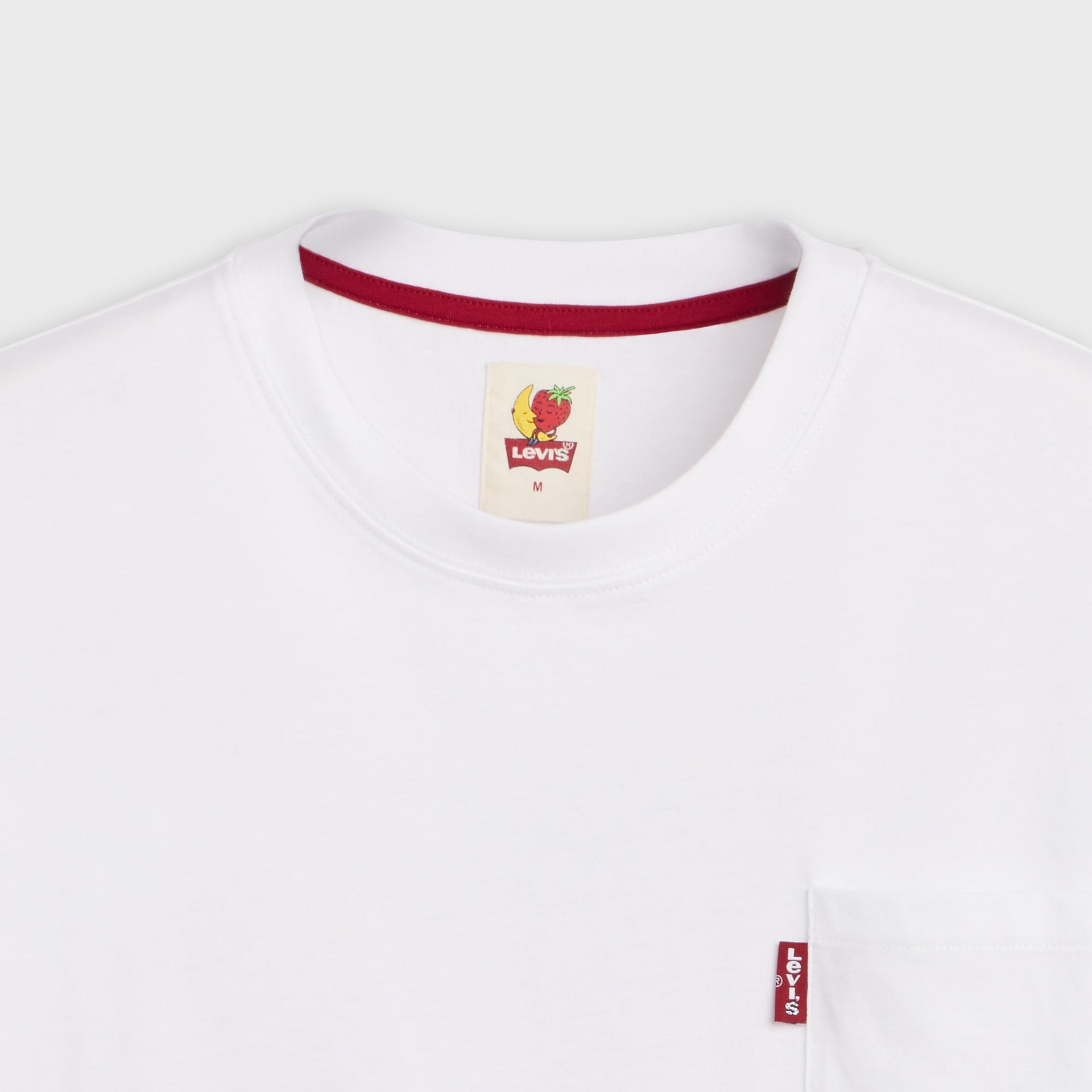 Collar detail of Levi's x Sky High Farm white pocket tee with red neck ribbing and banana-and-strawberry Levi's inner label