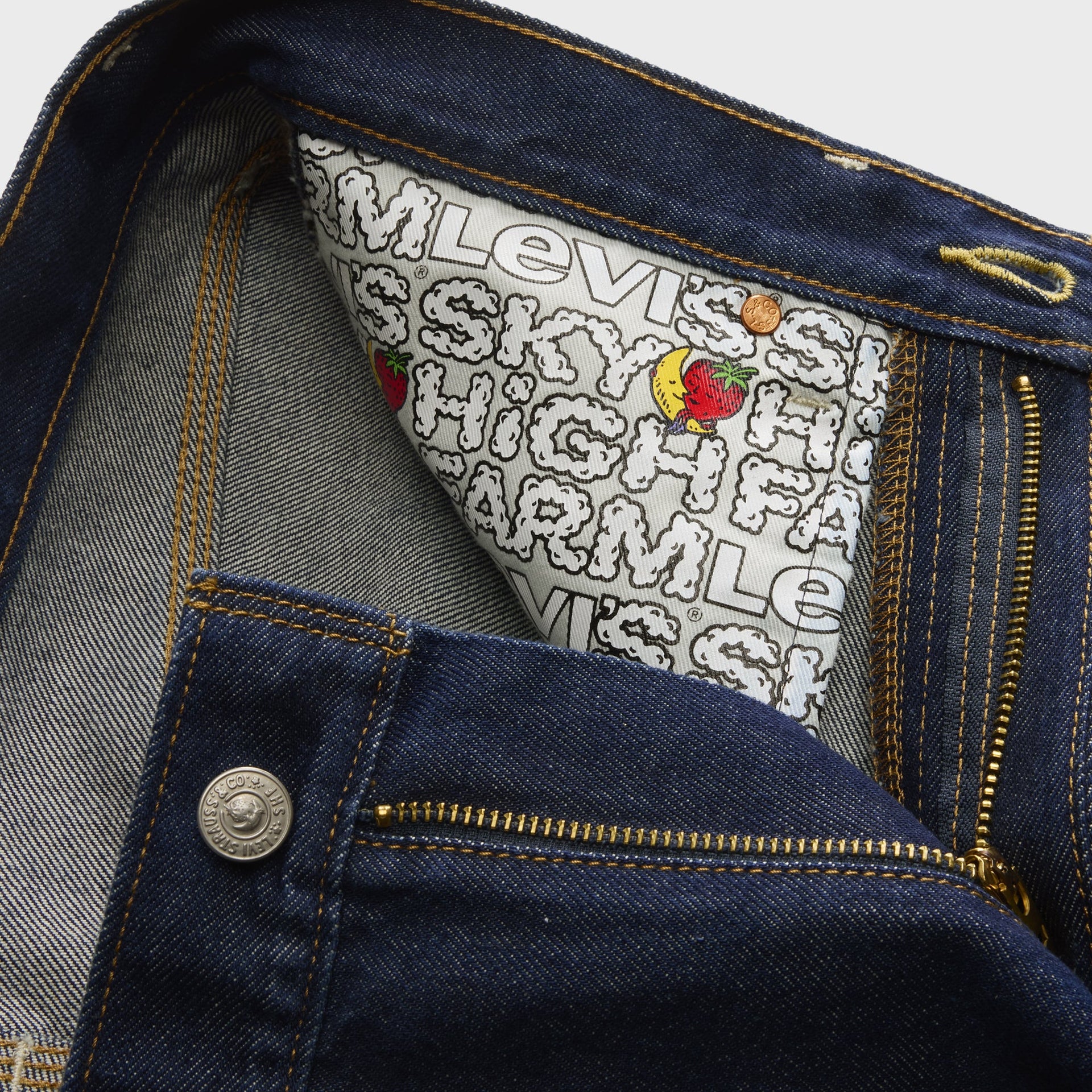 Interior waistband of Levi's x Sky High Farm loose jeans showing button fly and pocket bag printed with the collab logo