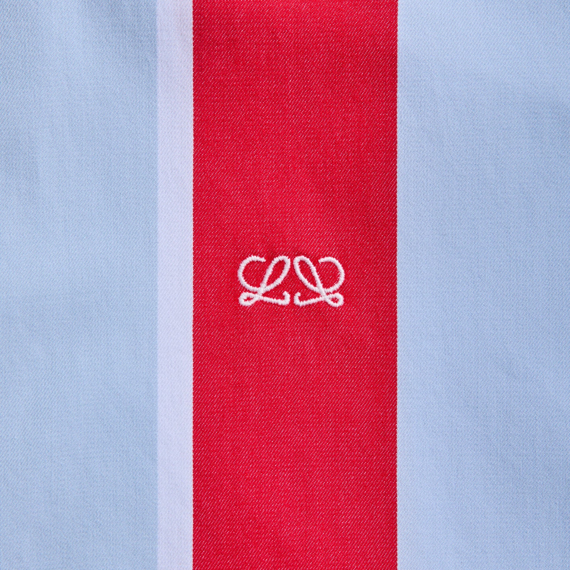 Detail of white Anagram embroidery on the red center stripe of Loewe multicolor striped cotton shirt