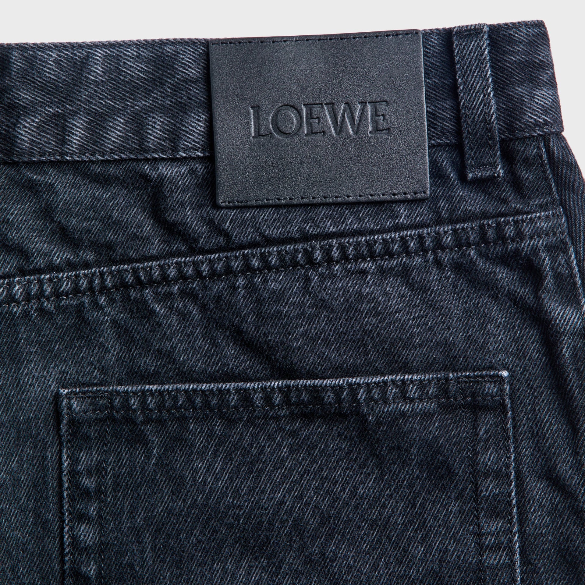 Loewe Anagram jeans detail, embossed LOEWE black leather waistband patch on washed black denim