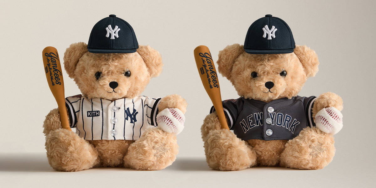 Two Kith for New York Yankees teddy bears in pinstripe and grey jerseys with NY caps, holding baseball bats and balls, desktop banner