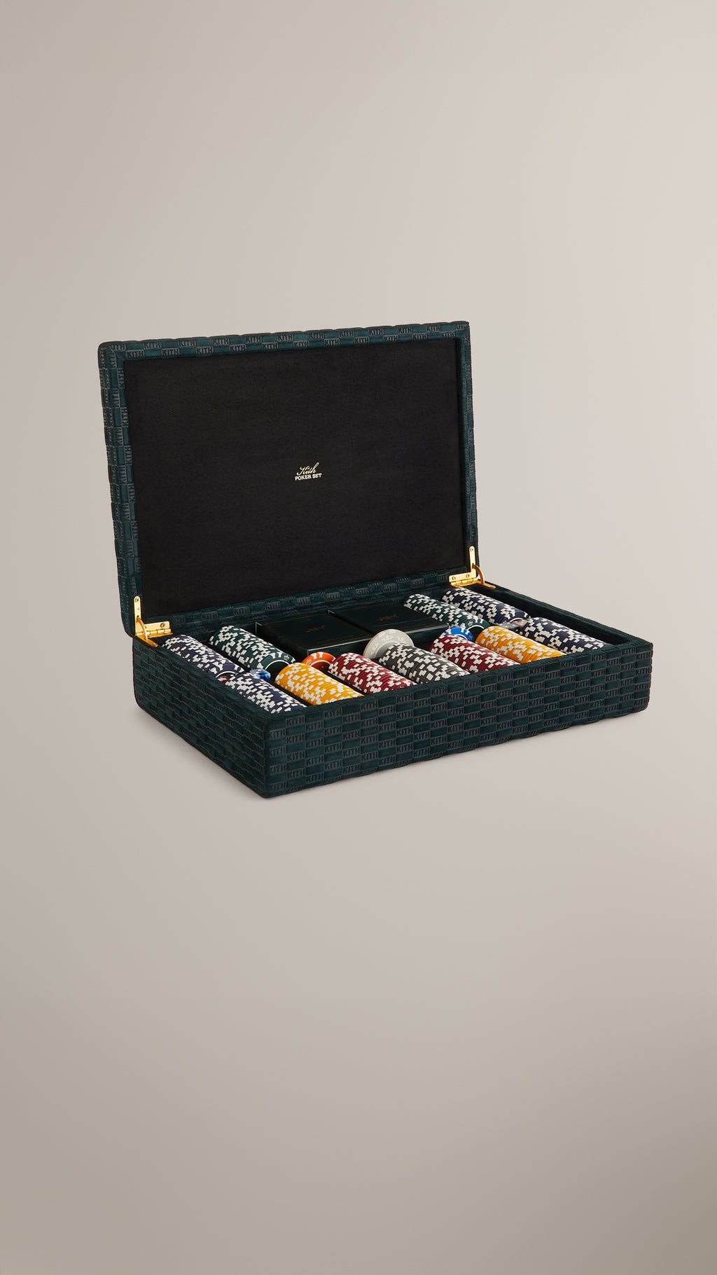 Open Kith Poker Set in a green KITH-monogram woven case with gold-embossed black suede lid and stacks of multicolor clay chips, vertical