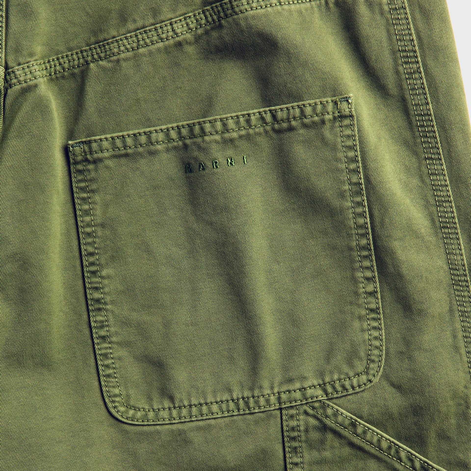 Close-up of Marni garden green workwear trousers: back patch pocket with tonal MARNI embroidery and heavy contrast stitching