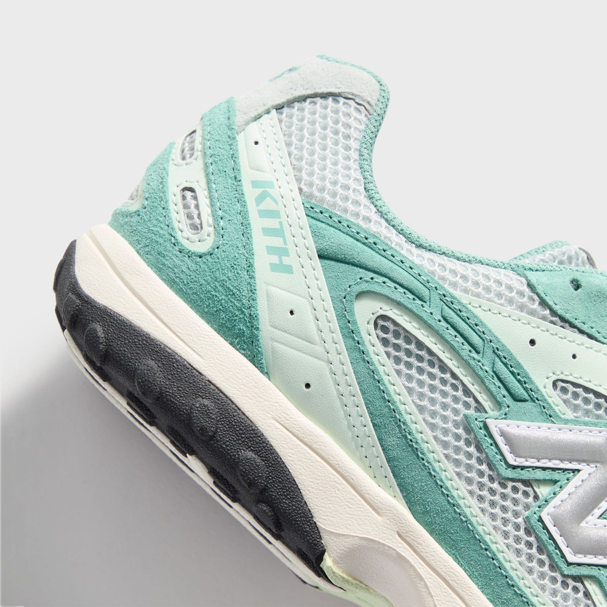 Kith & New Balance 204L in Bluebell, close-up of teal suede midfoot with KITH wordmark and silver N logo