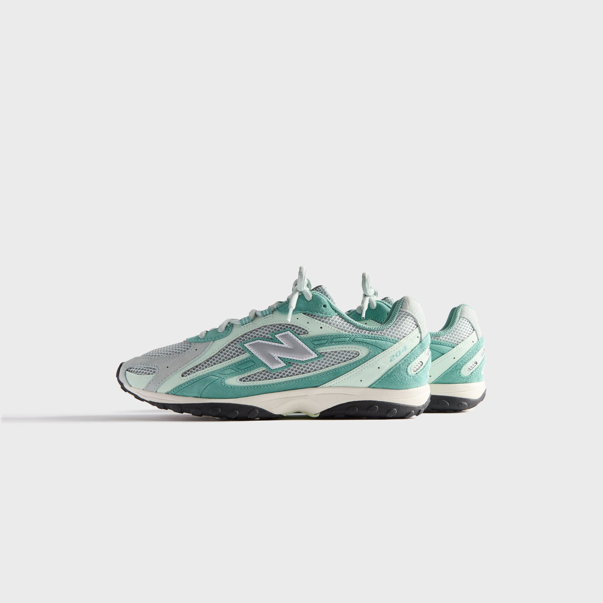 Kith & New Balance 204L in Bluebell, medial side profile showing inner N logo, mint mesh and teal suede overlays