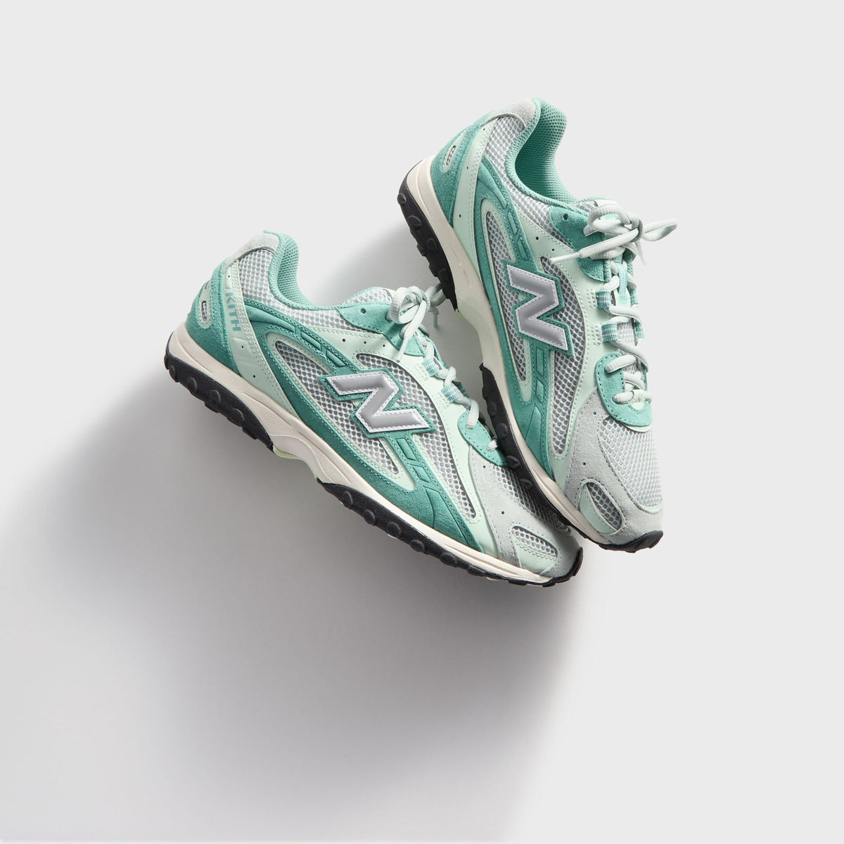 Kith & New Balance 204L in Bluebell, overhead angled view of the pair with laces and silver N logos facing up
