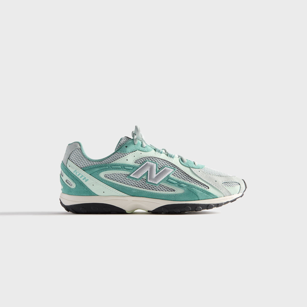 Kith & New Balance 204L in Bluebell, lateral profile of the right sneaker in mint and teal with grey mesh and silver N logo