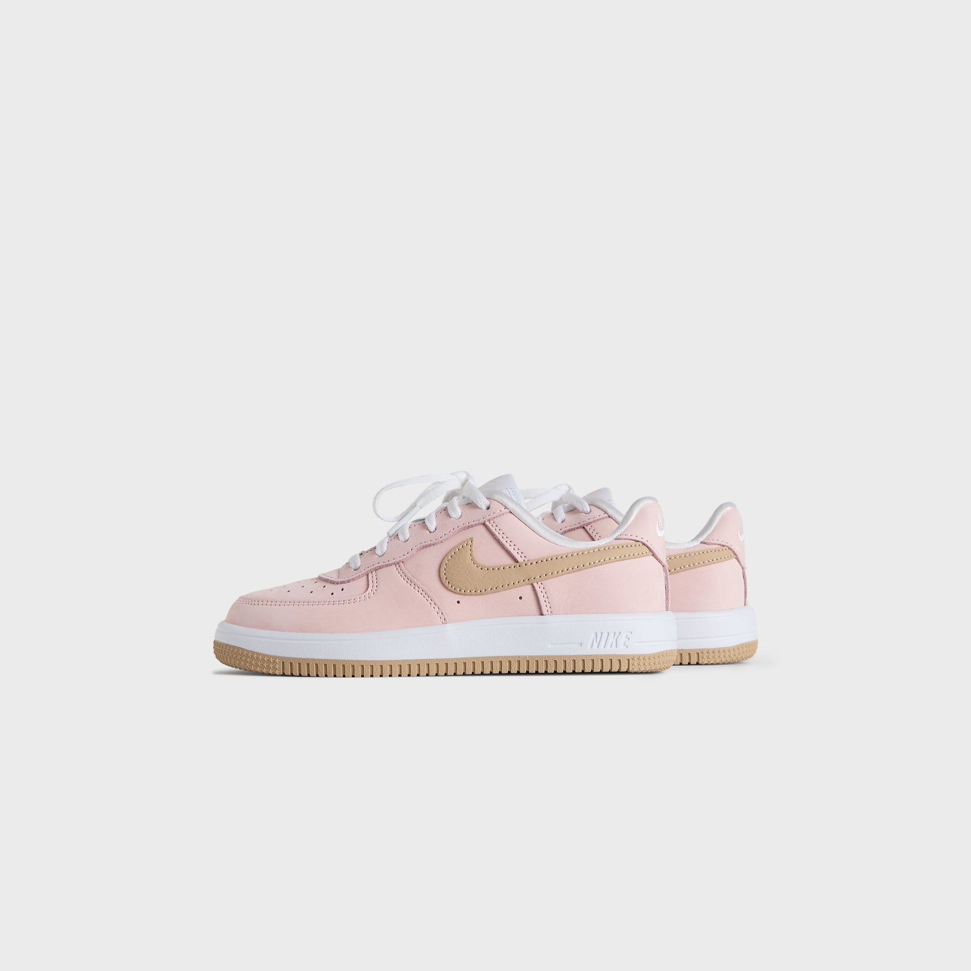 Kith Kids x Nike PS Air Force 1 Un-Linen pair, small front three-quarter angle, pink upper and wheat suede Swoosh