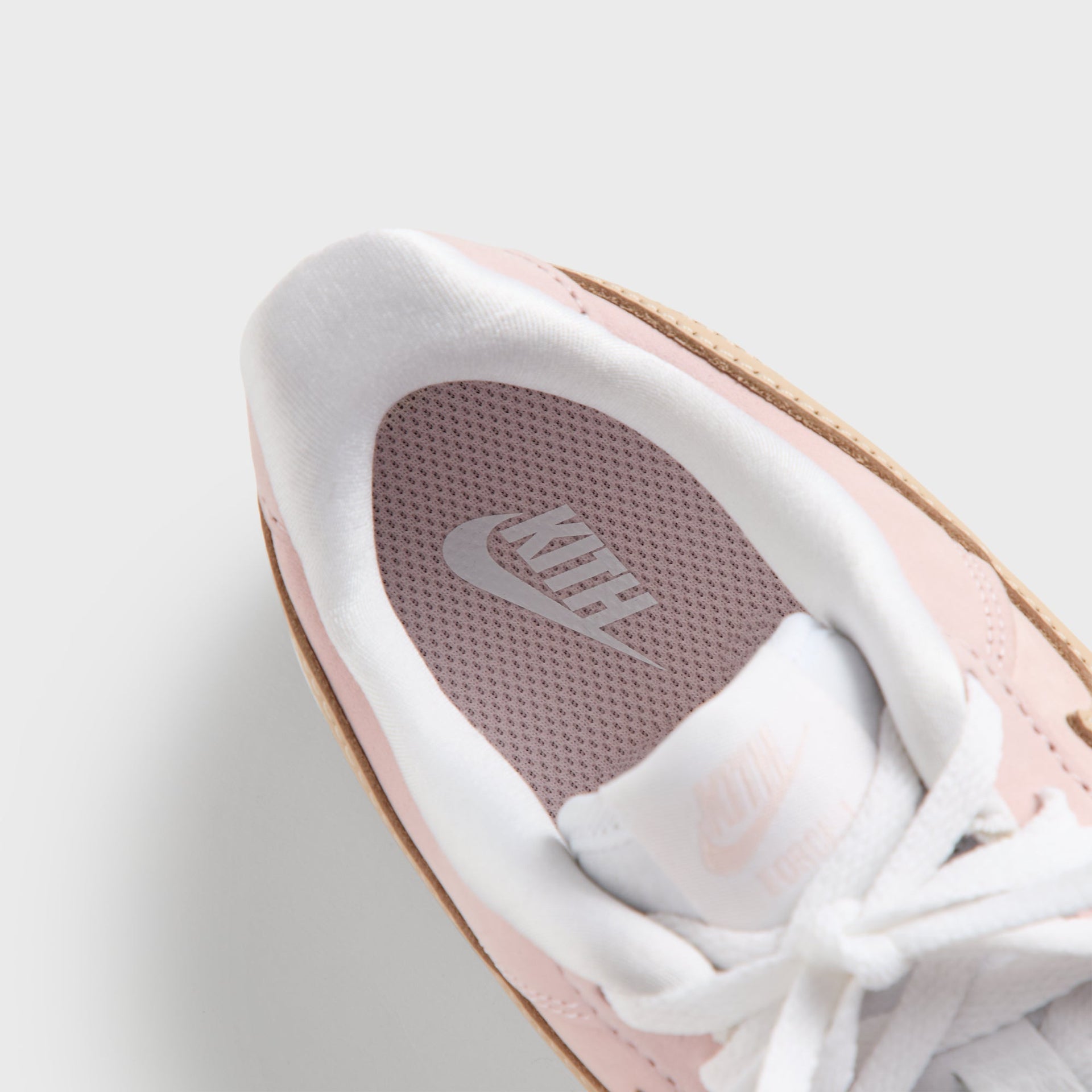 Footbed of the Kith Kids x Nike PS Air Force 1 Un-Linen showing pink Kith and Nike insole branding
