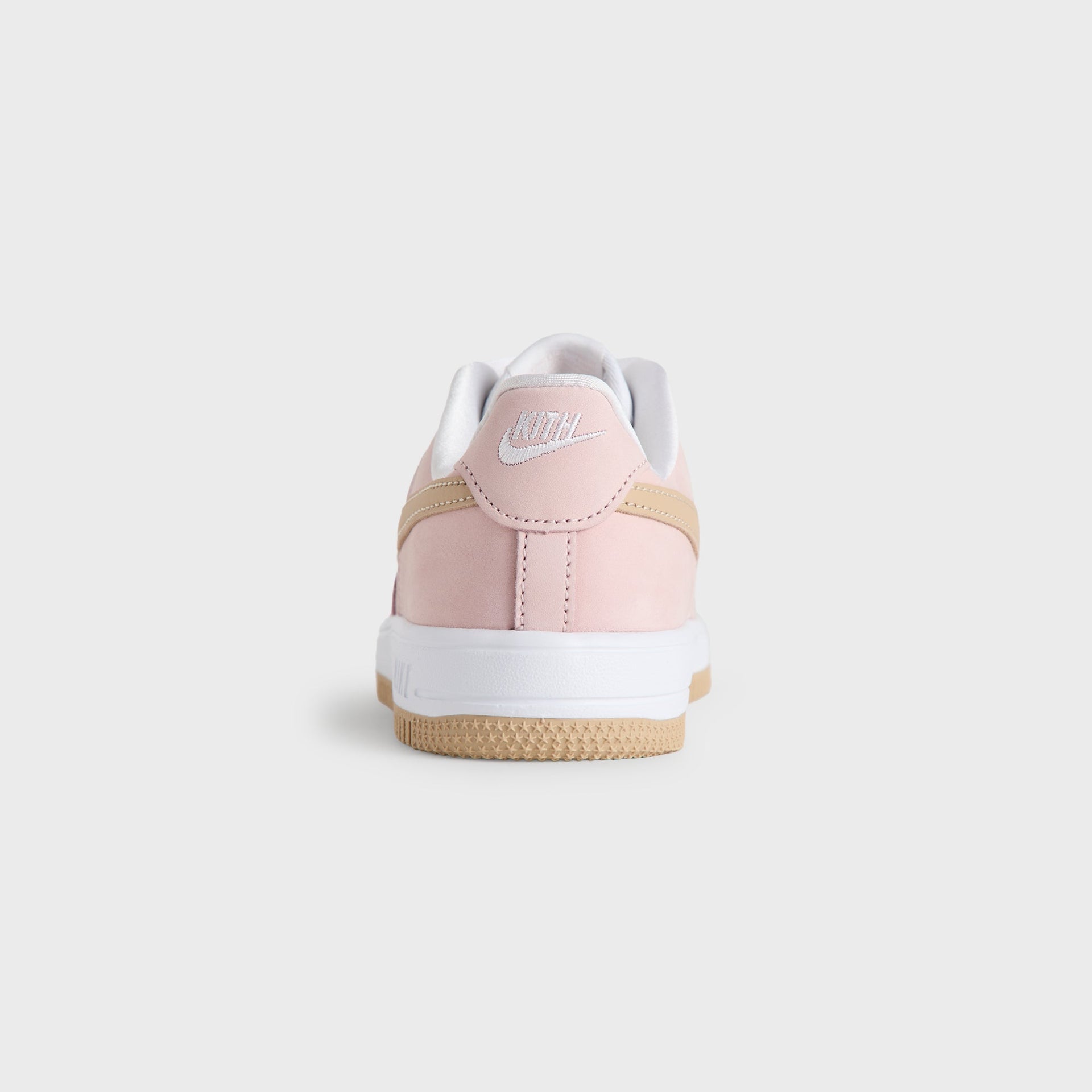 Heel view of the Kith Kids x Nike PS Air Force 1 Un-Linen in Atmosphere pink with a white Nike heel logo