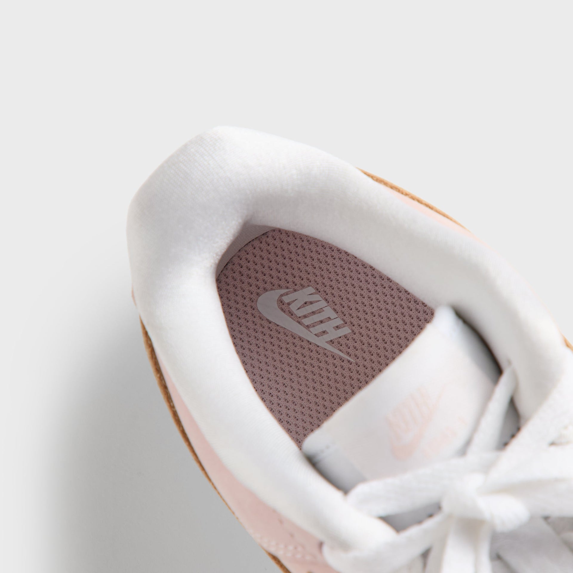 Footbed of the Kith Kids x Nike TD Air Force 1 Un-Linen showing pink Kith and Nike insole branding