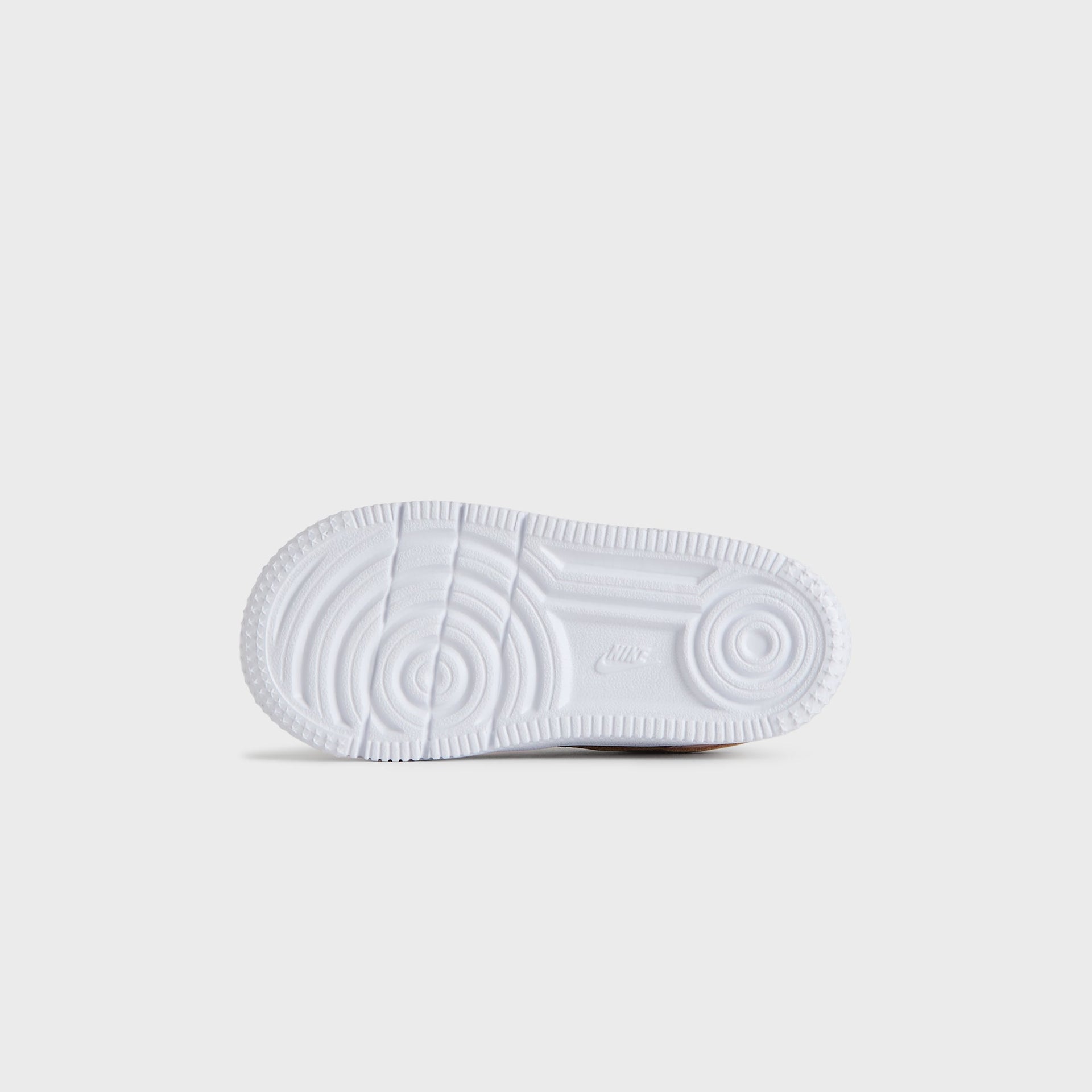 White outsole of the Kith Kids x Nike TD Air Force 1 Un-Linen, seen from below