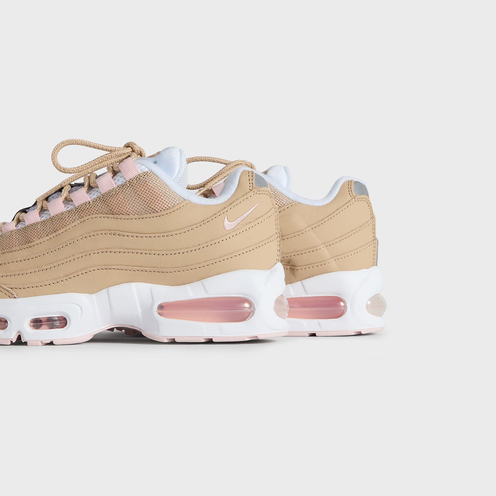Kith Kids x Nike GS Air Max 95 Linen pair viewed from the heel and outer side, pink Air soles