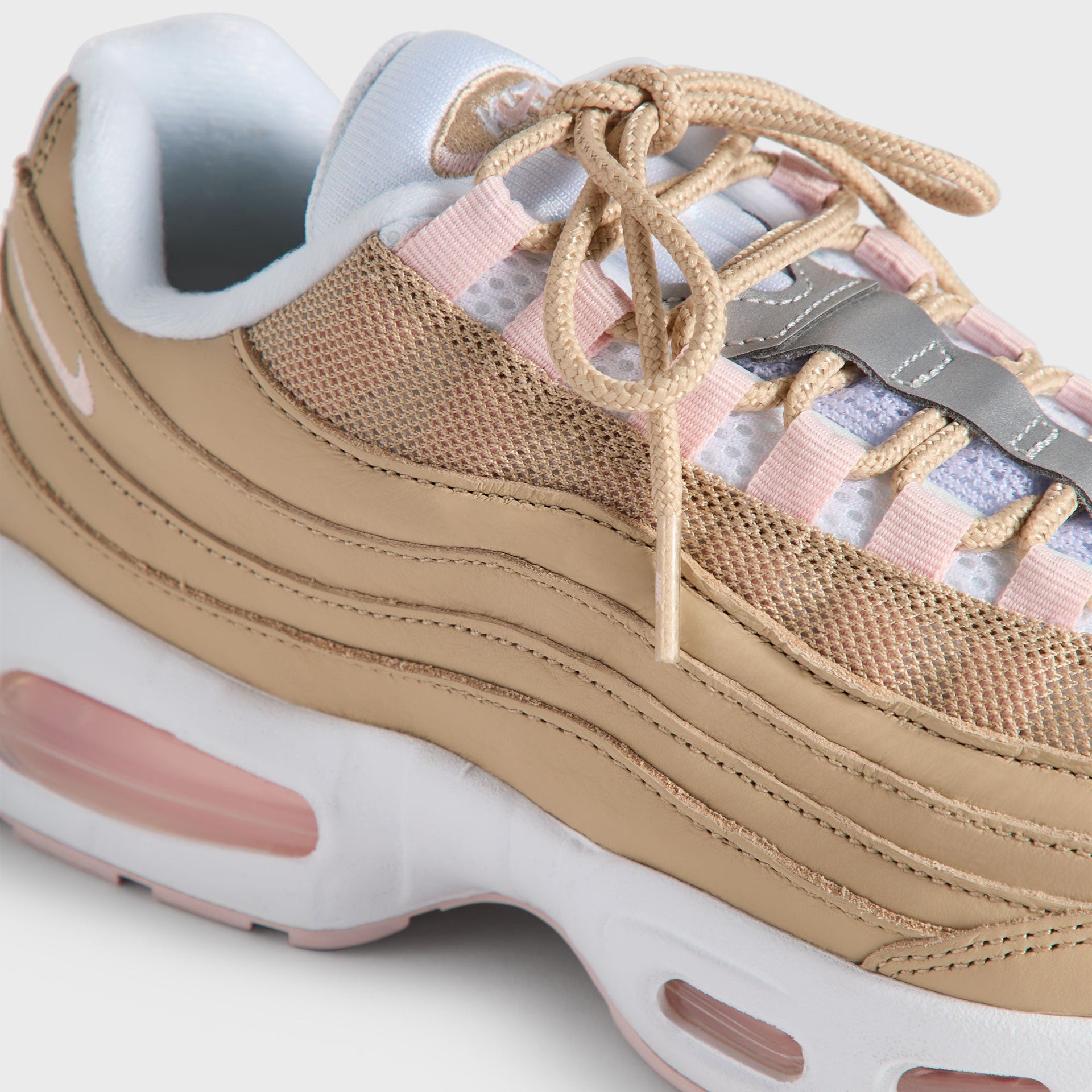 Close-up of the Kith Kids x Nike GS Air Max 95 Linen laced tongue, pink panels and light-blue lining