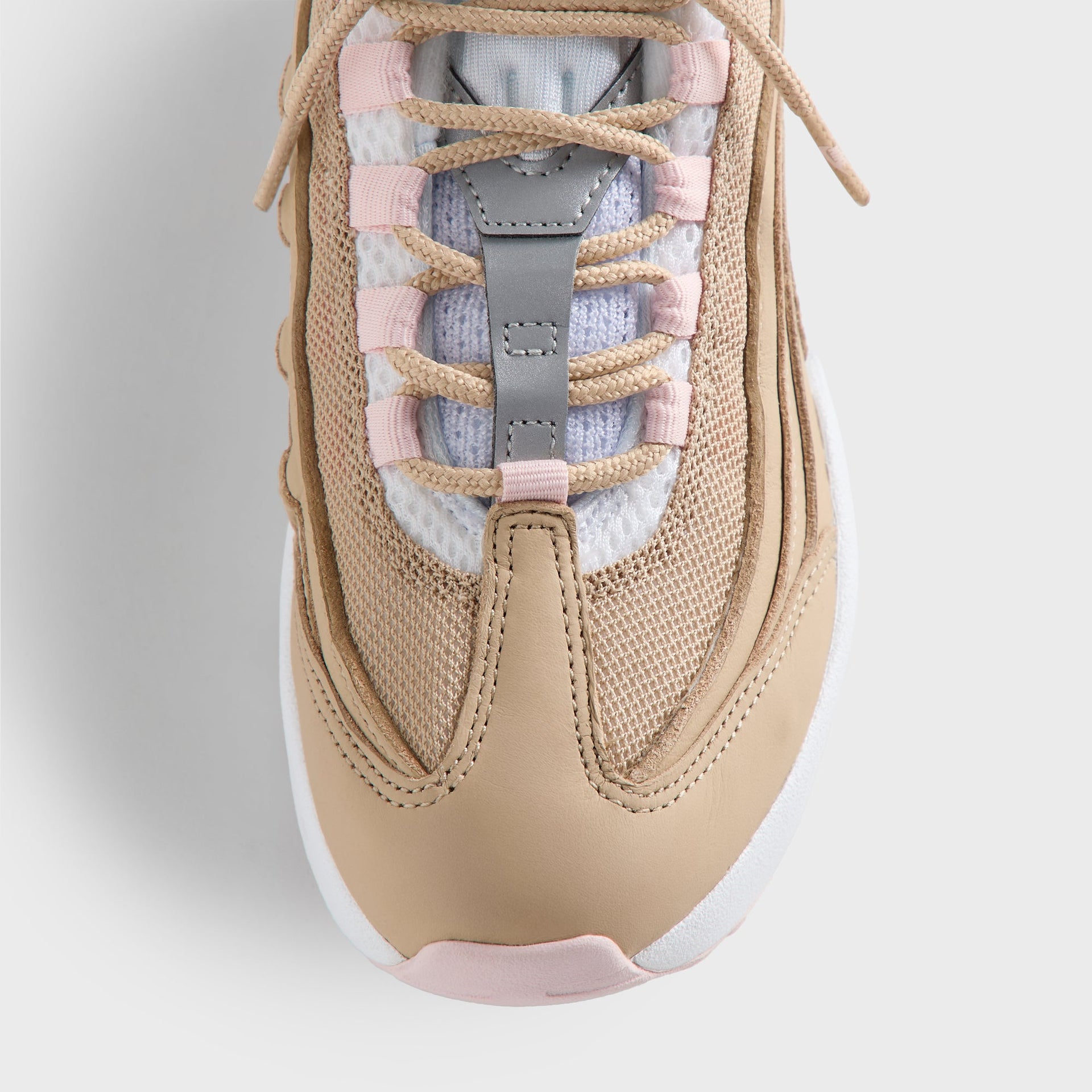 Close-up of the Kith Kids x Nike PS Air Max 95 Linen laced tongue, pink panels and light-blue lining