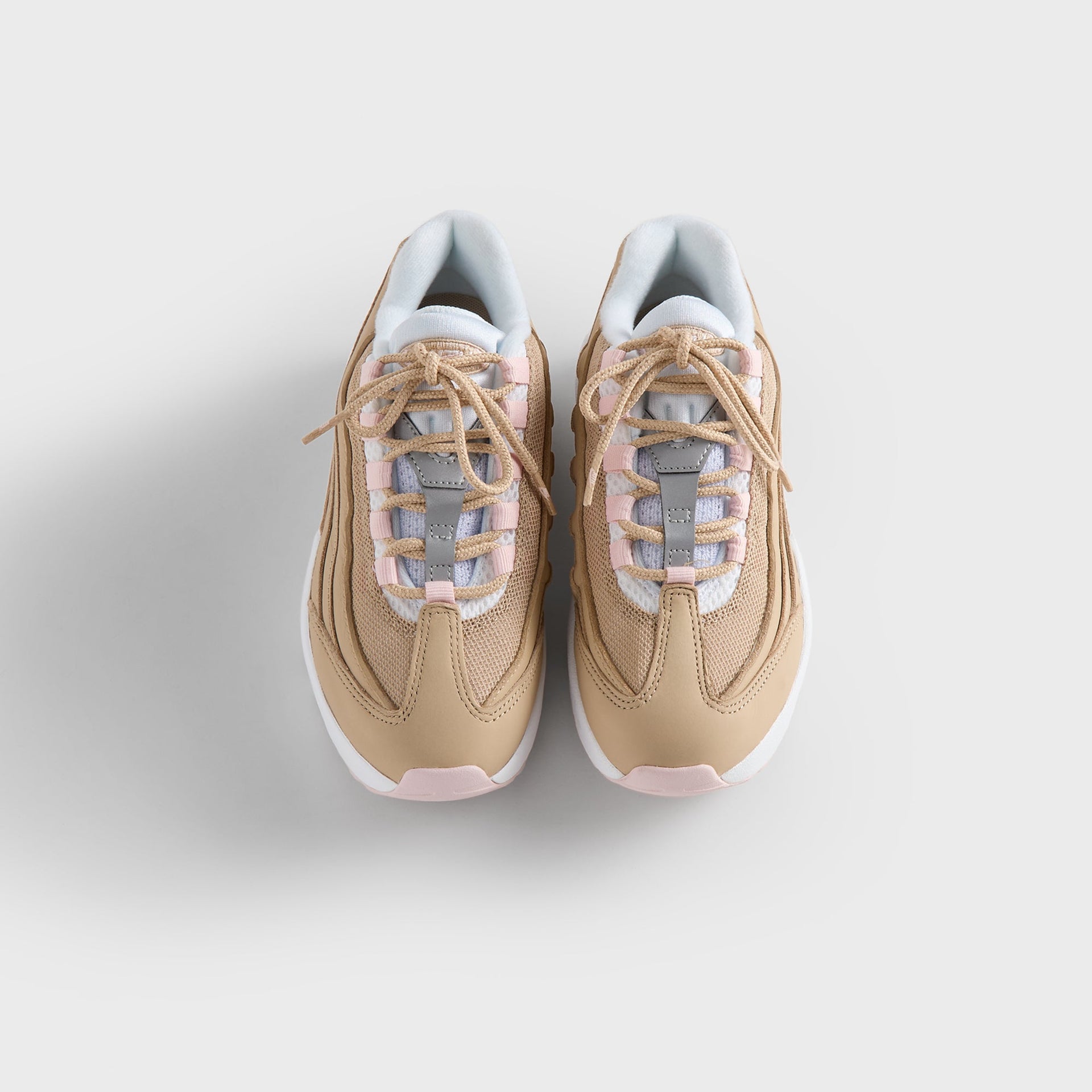 Kith Kids x Nike PS Air Max 95 Linen pair from above, tan laces over pink-and-white tongues (additional studio view)
