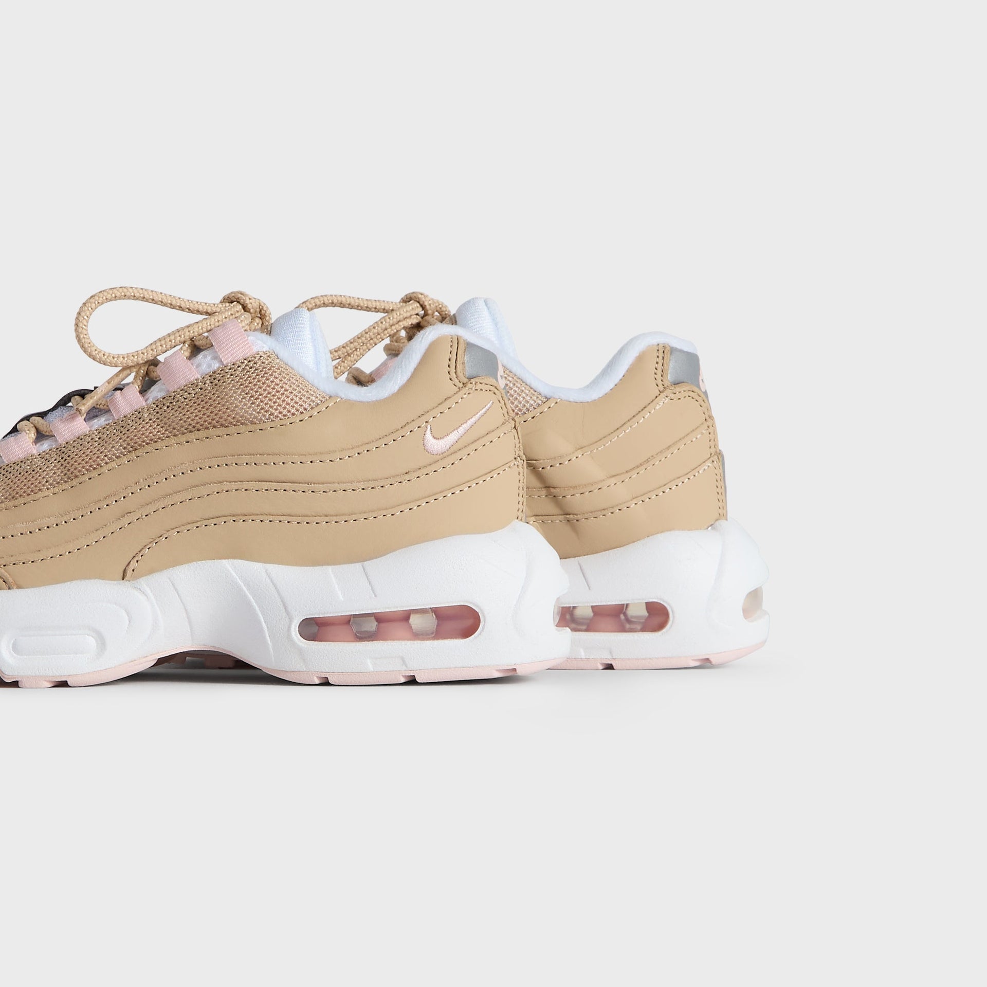 Kith Kids x Nike PS Air Max 95 Linen pair viewed from the heel and outer side, pink Air soles