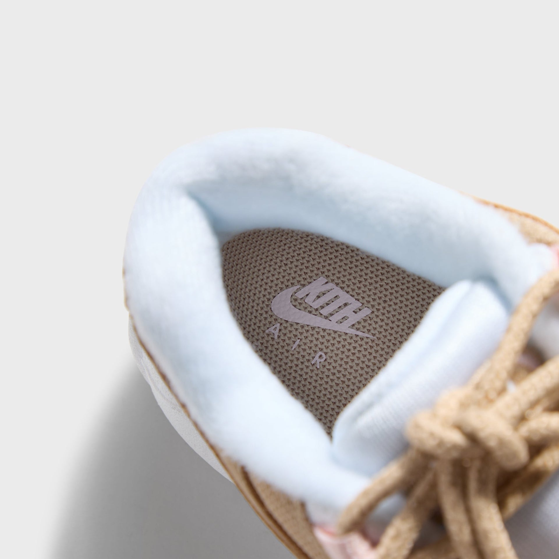 Footbed of the Kith Kids x Nike TD Air Max 95 Linen with Kith insole branding and blue lining (additional studio view)