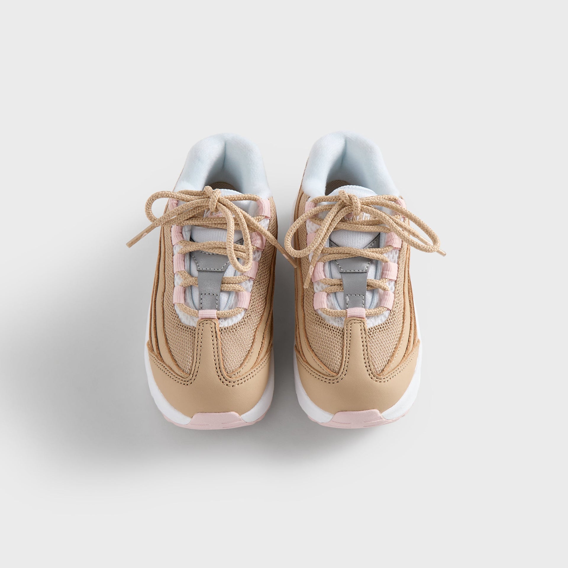Kith Kids x Nike TD Air Max 95 Linen pair from above, tan laces over pink-and-white tongues (additional studio view)