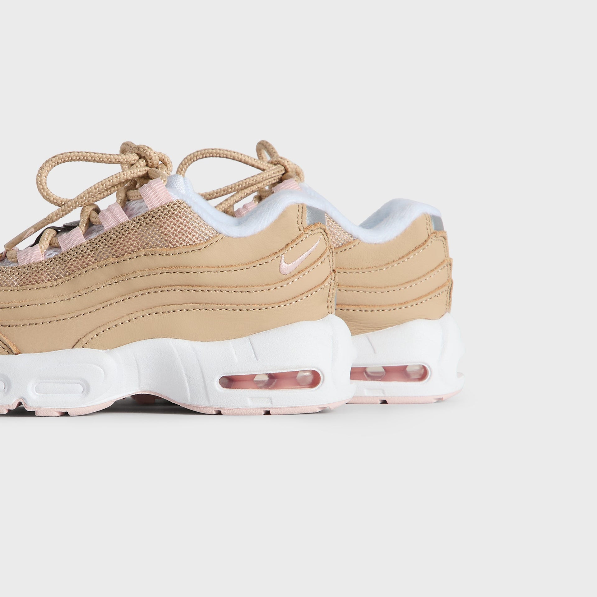 Kith Kids x Nike TD Air Max 95 Linen pair viewed from the heel and outer side, pink Air soles