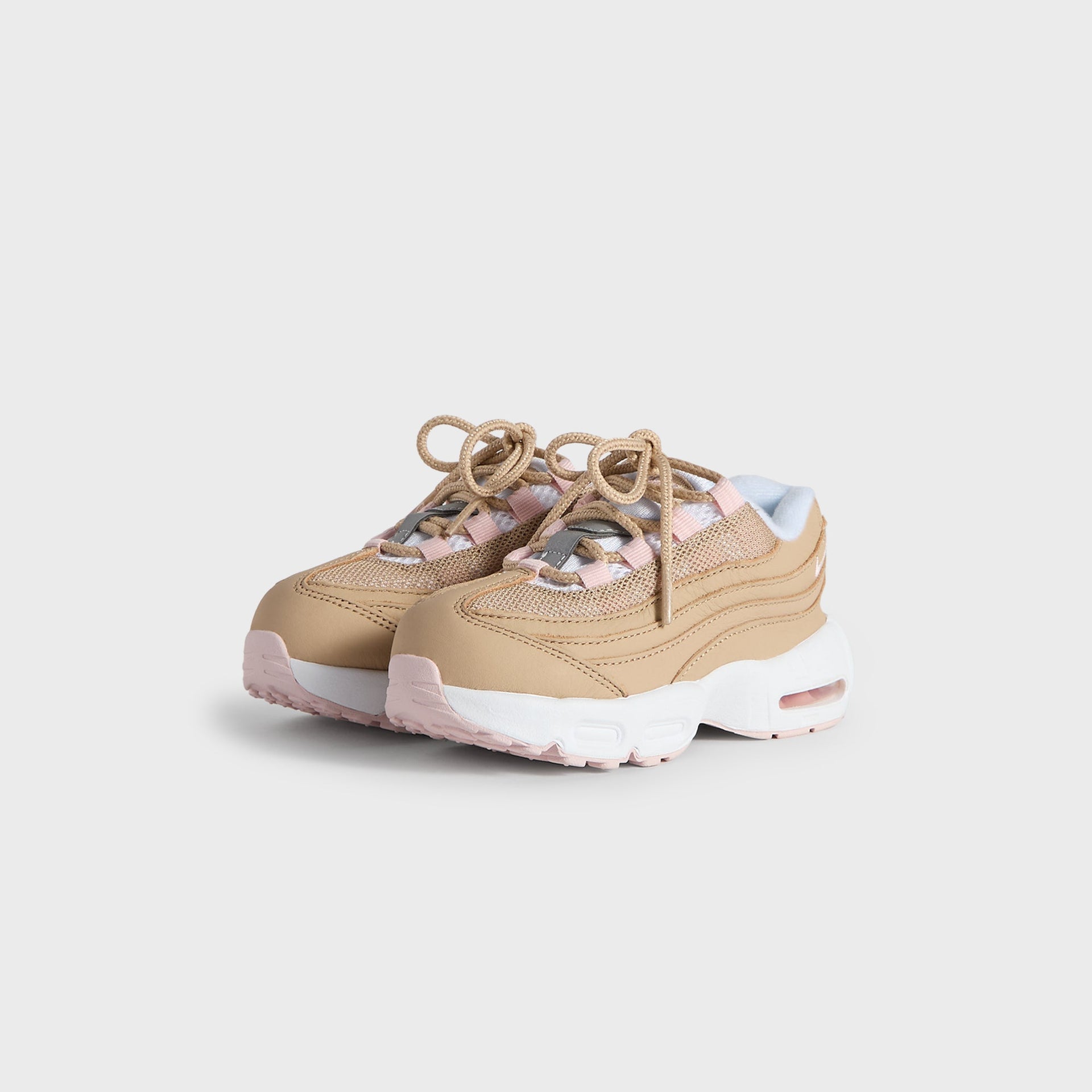 Kith Kids x Nike TD Air Max 95 Linen pair angled from the front, linen upper with pink accents and tan laces (additional studio view)