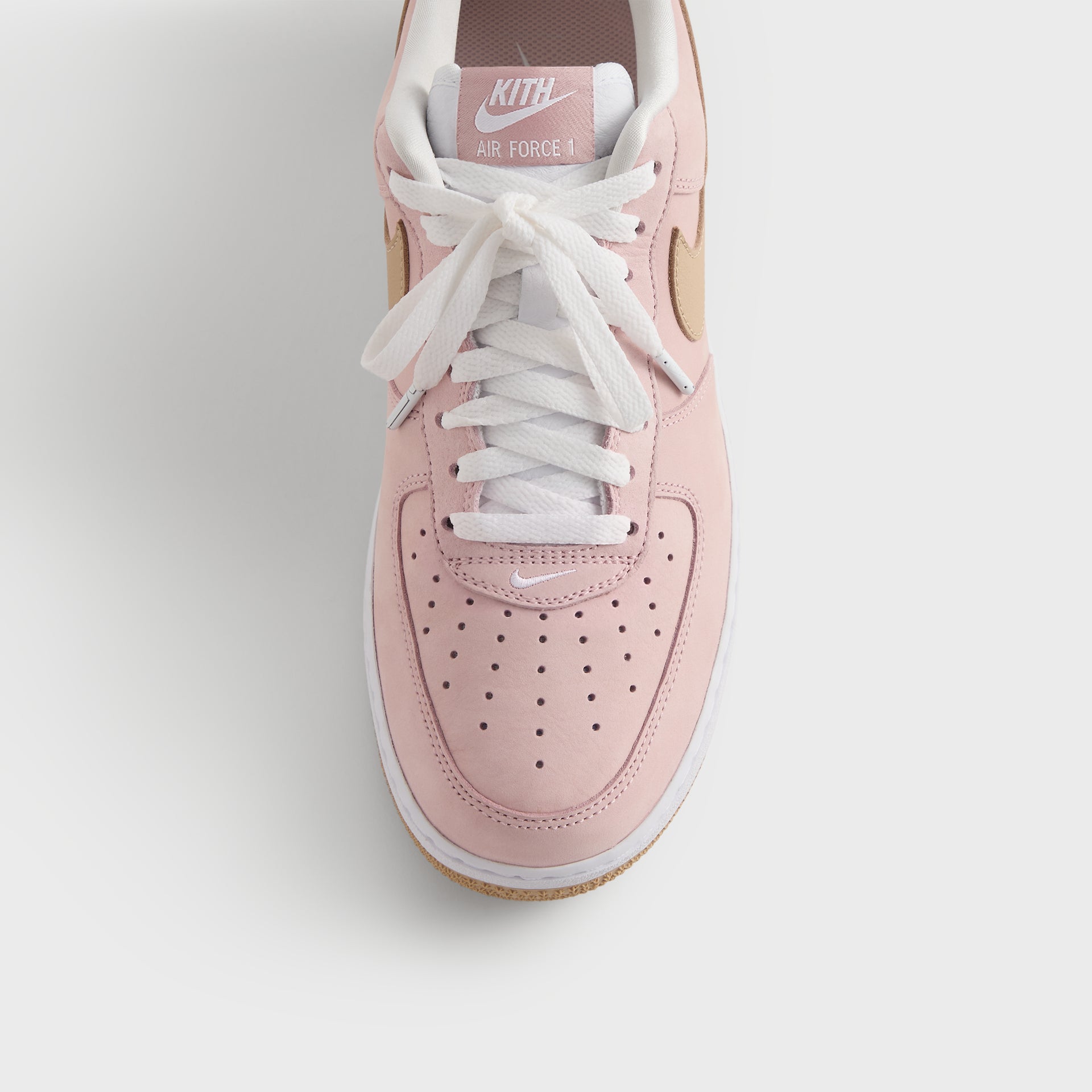 Close-up of the Kith x Nike Air Force 1 Un-Linen perforated pink toe box and wheat Swoosh