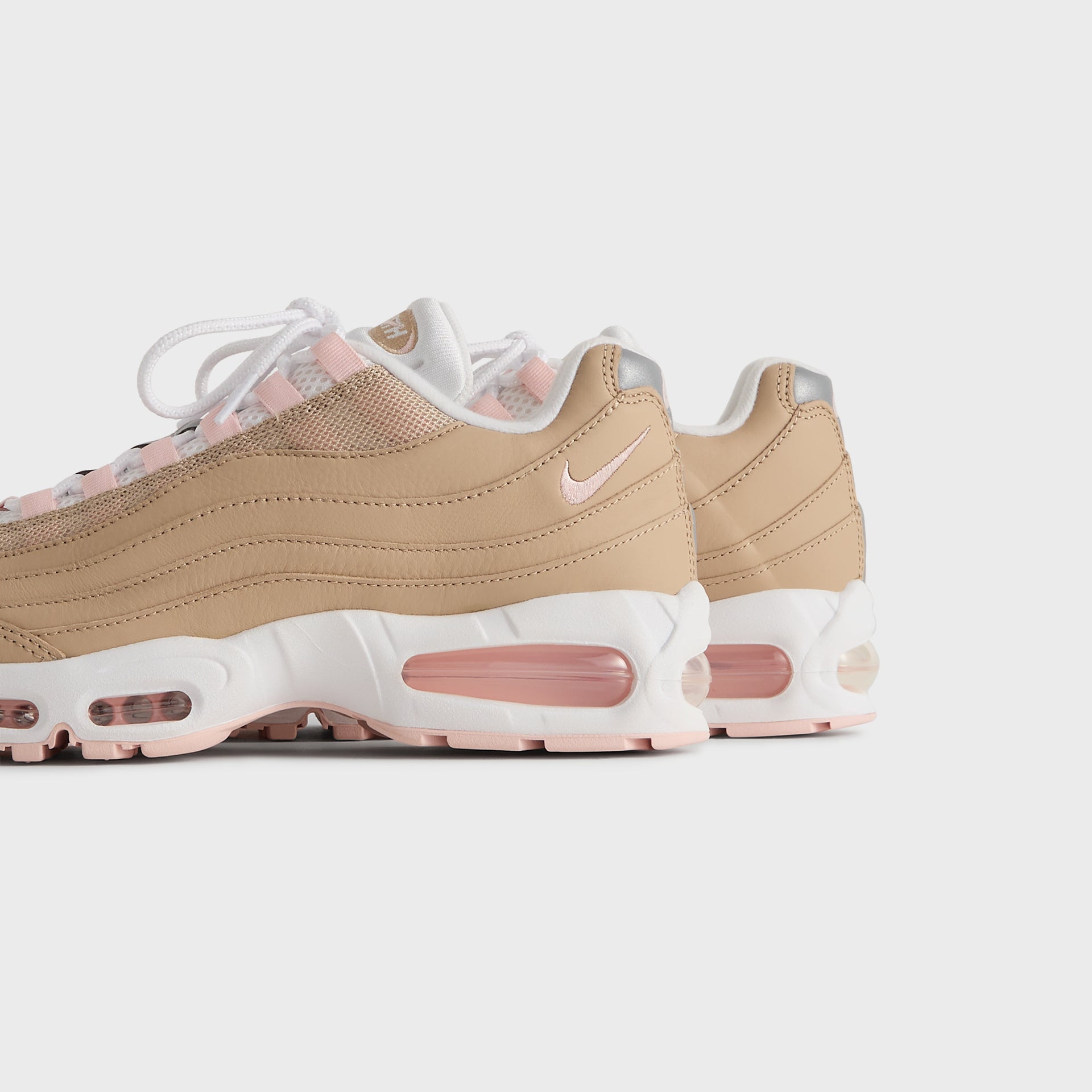 Kith x Nike Air Max 95 Linen pair viewed from the heel and outer side, pink Air soles