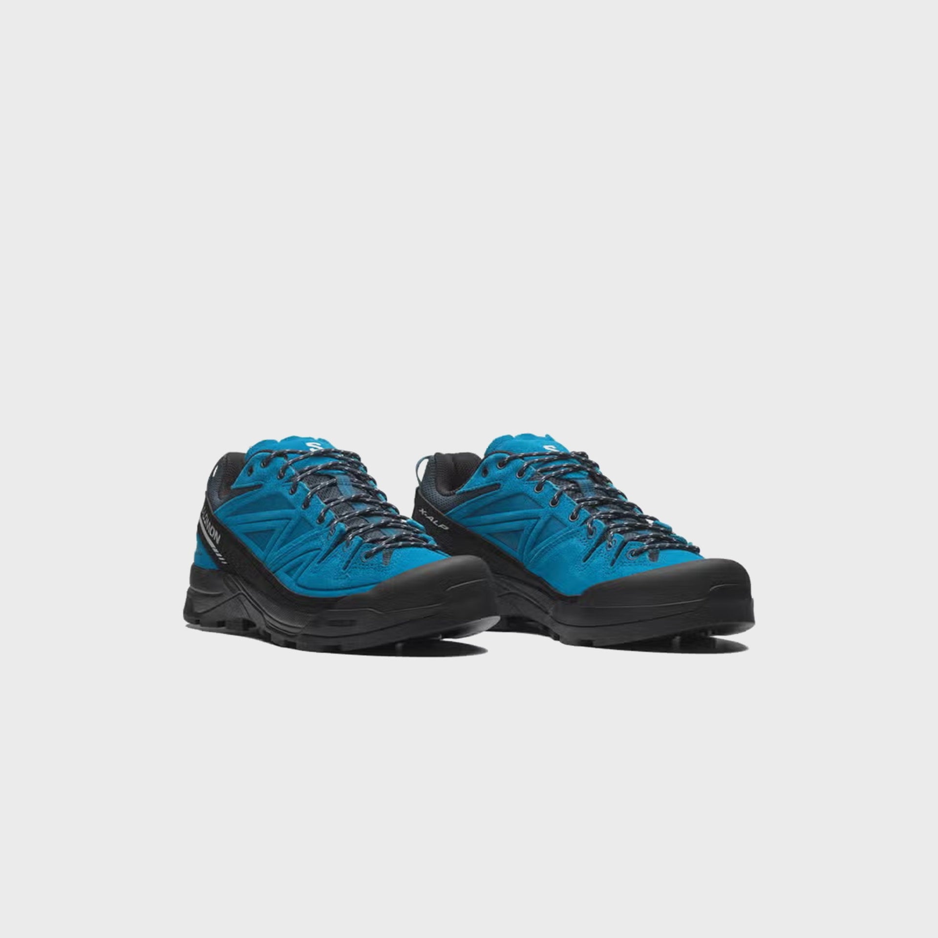 Pair of Salomon X-ALP LTR hiking shoes in bright blue suede, front three-quarter view showing black toe caps