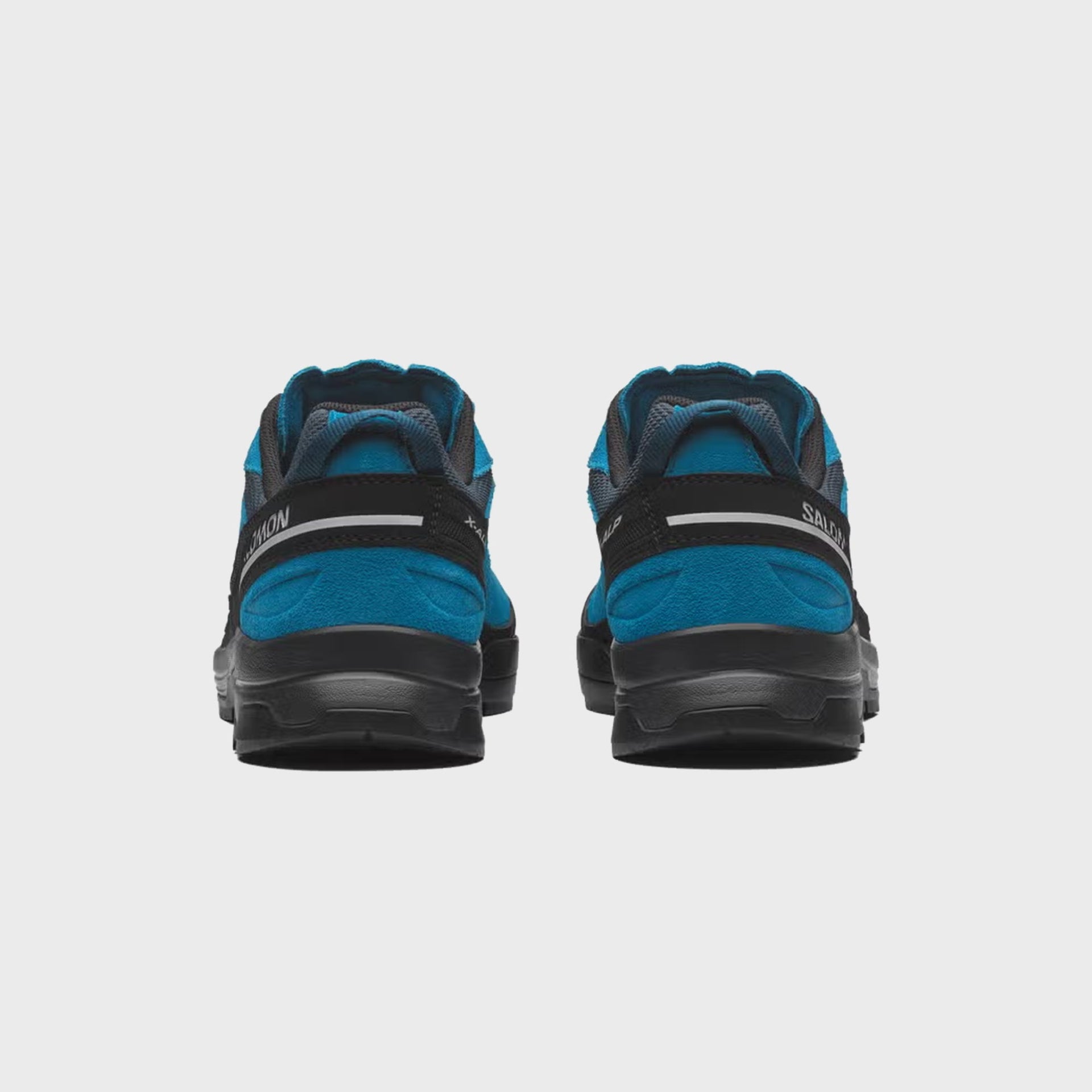 Pair of Salomon X-ALP LTR hiking shoes, rear heel view with Salomon and X-ALP text on the black heel counter